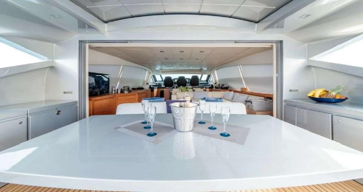 a white table with glasses and plates on it aboard FOR EVER Yacht for Charter
