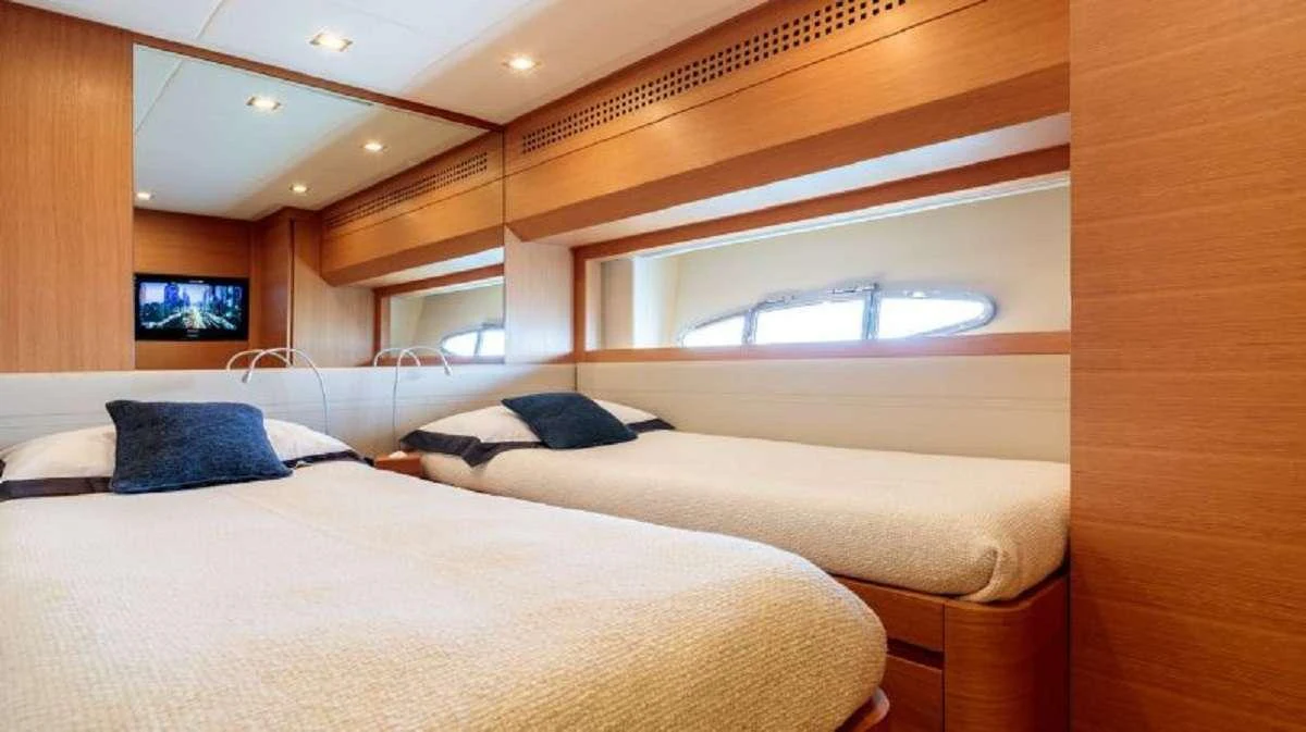 a room with a bed and a television aboard FOR EVER Yacht for Charter