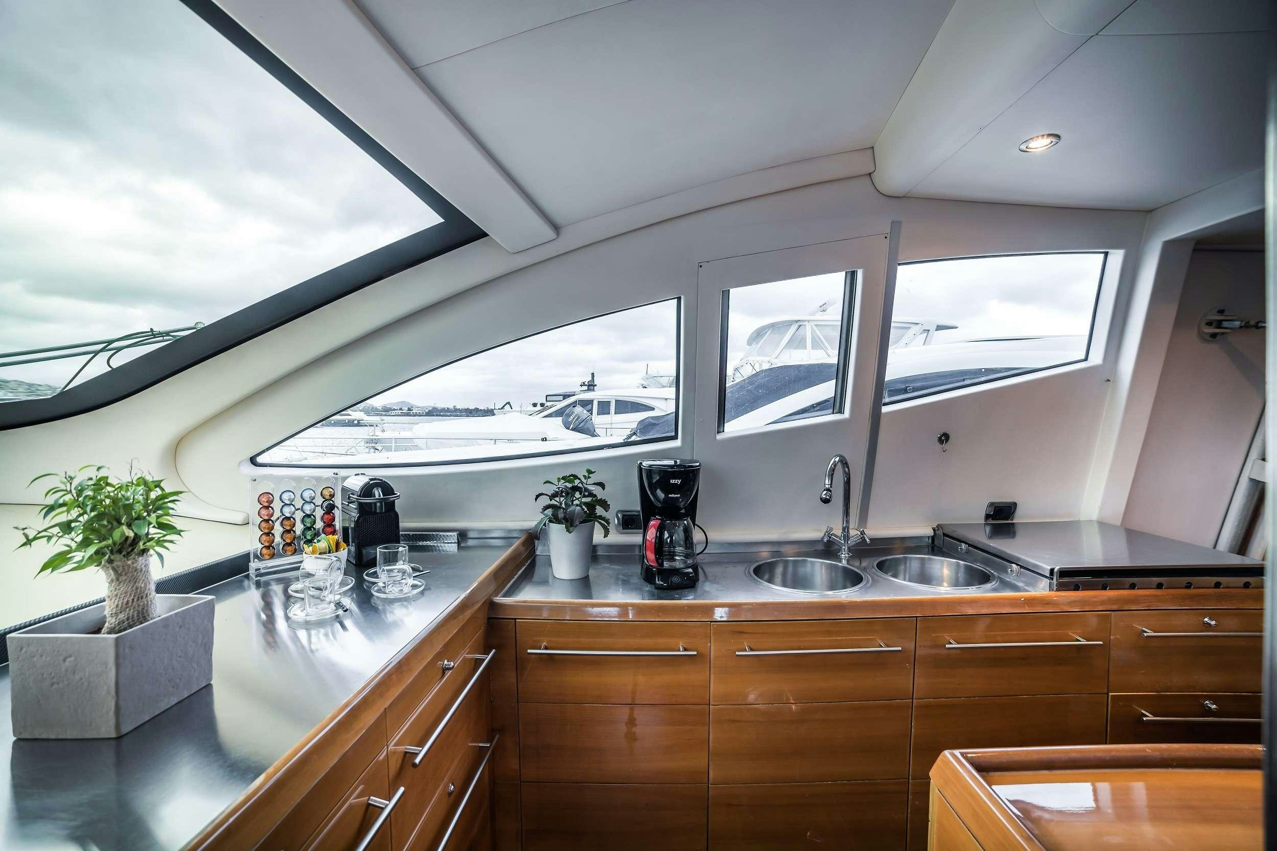 a kitchen with a large window aboard SUMMER THERAPY Yacht for Charter