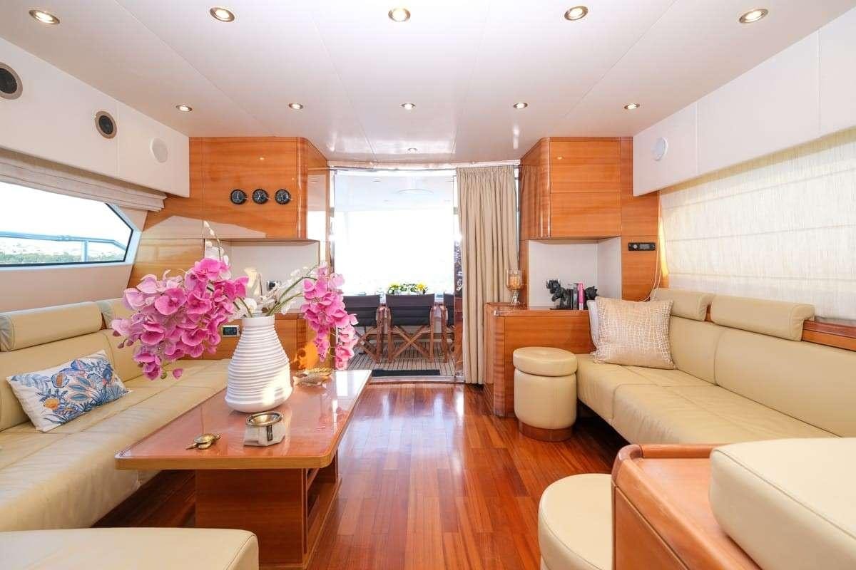 a living room with a couch and a table aboard SUMMER THERAPY Yacht for Charter