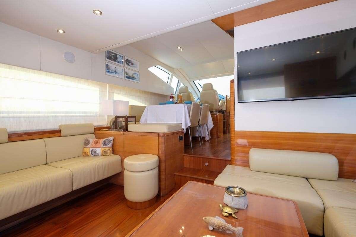 a living room with a couch and a table aboard SUMMER THERAPY Yacht for Charter