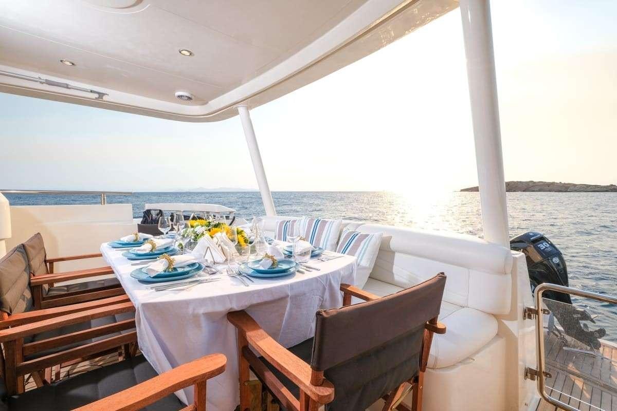 a table set for a meal on a boat aboard SUMMER THERAPY Yacht for Charter