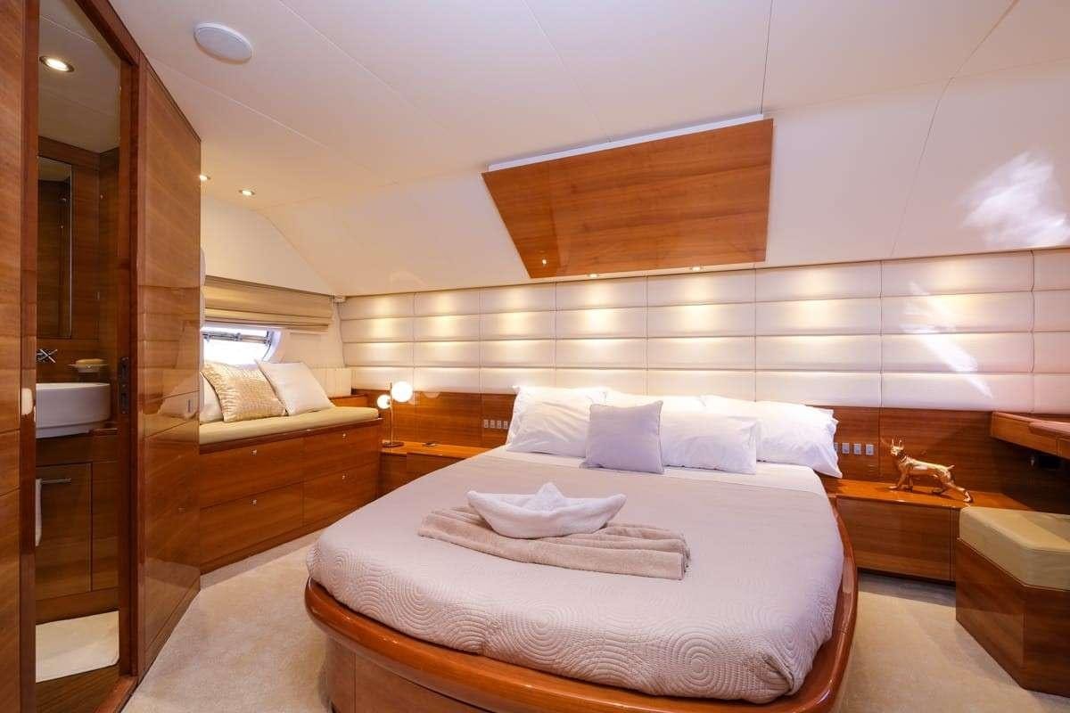 a room with a bed and a mirror aboard SUMMER THERAPY Yacht for Charter
