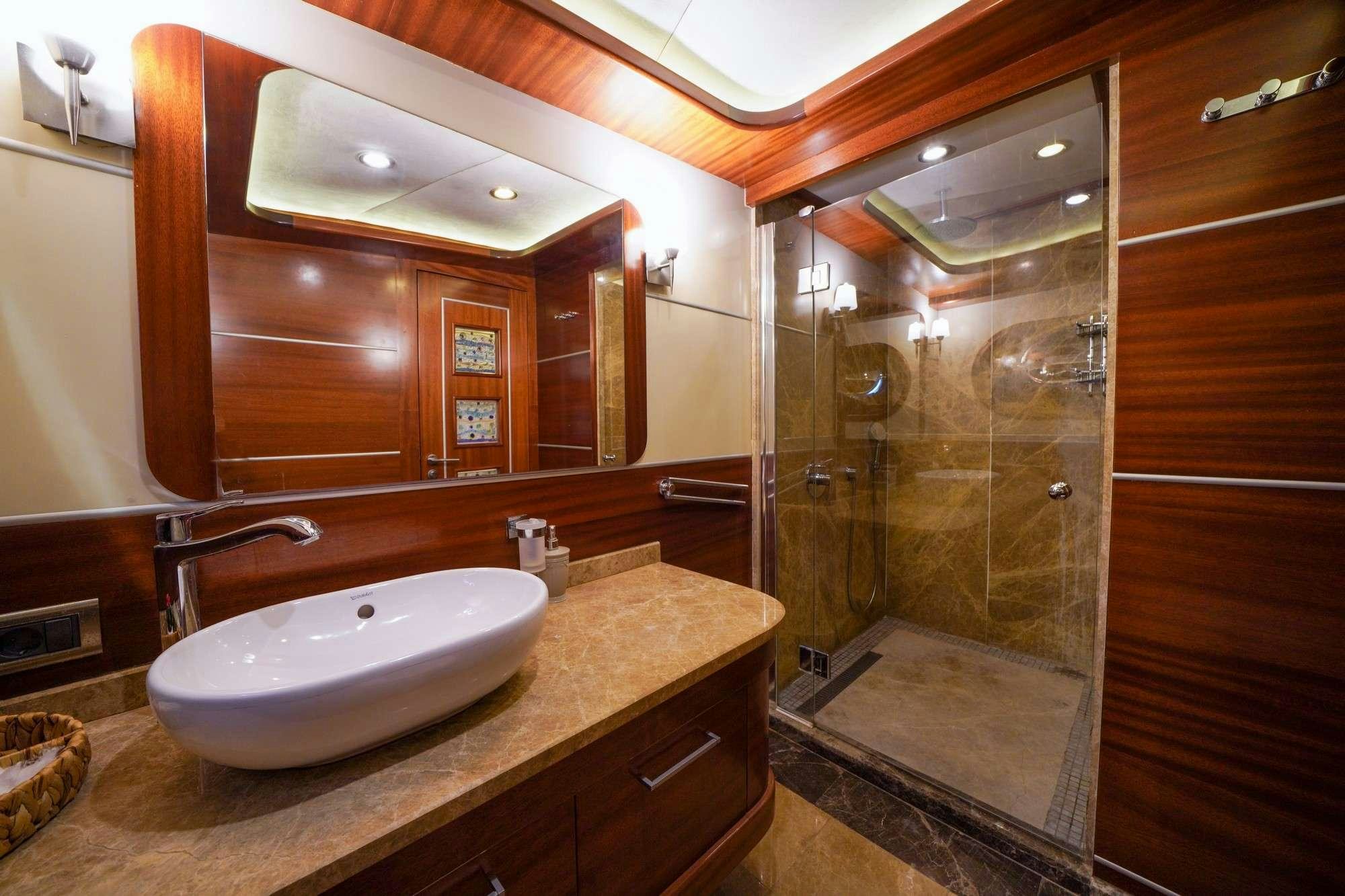 a bathroom with a sink and a shower aboard LA BELLA VITA Yacht for Charter