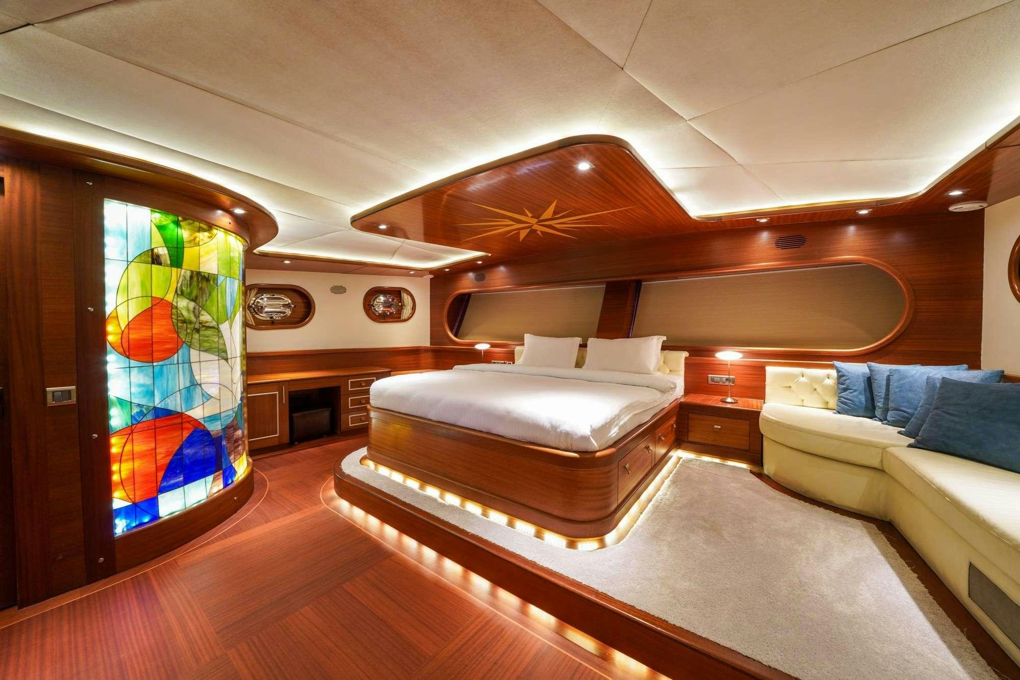 a room with a couch and a tv in it aboard LA BELLA VITA Yacht for Charter