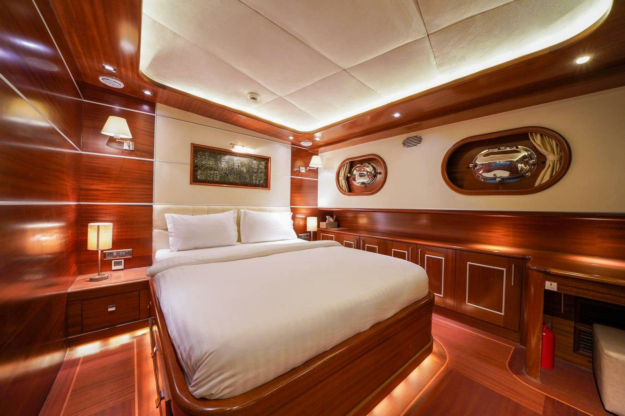 a room with a bed and a wood wall aboard LA BELLA VITA Yacht for Charter