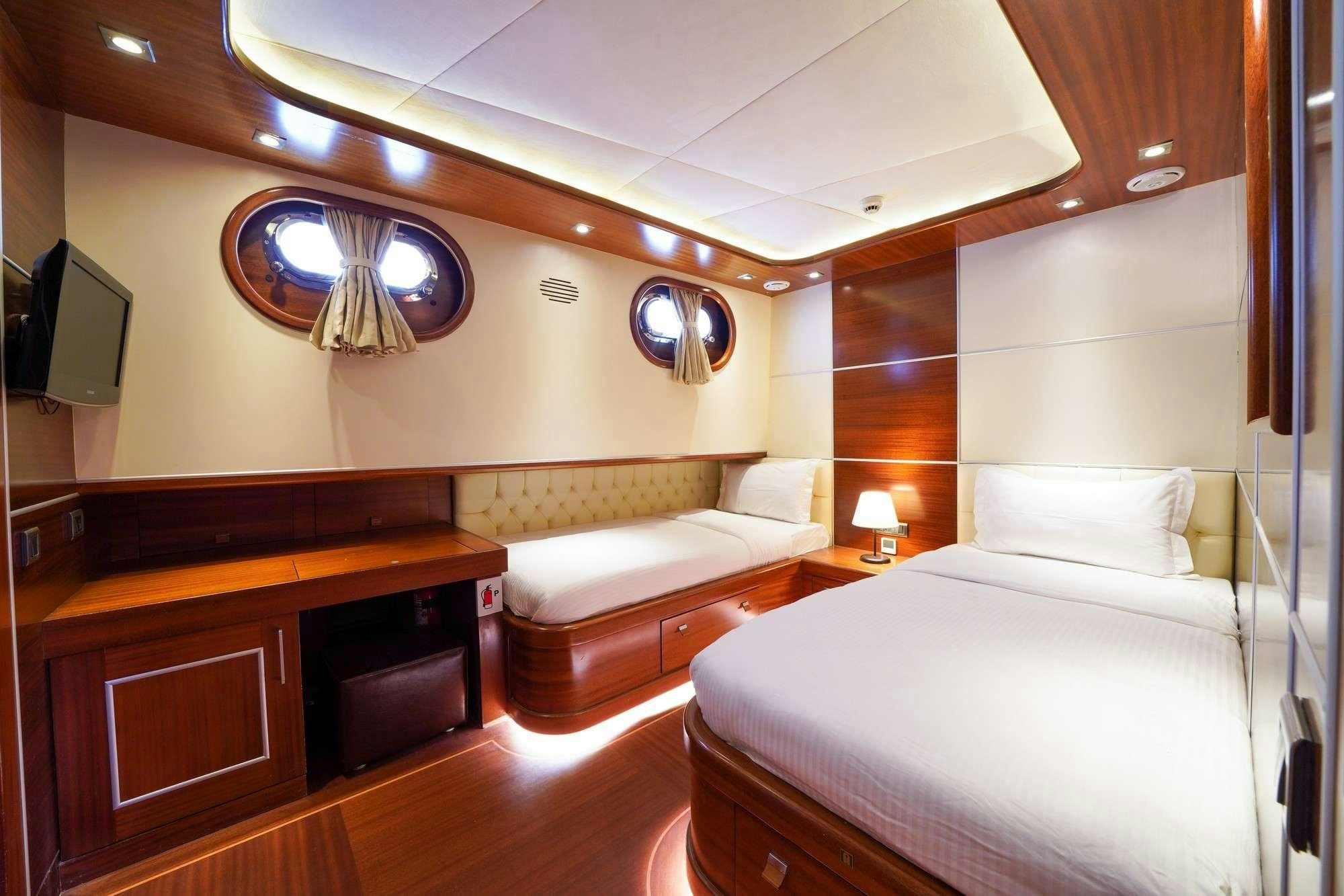 a room with a bed and a desk aboard LA BELLA VITA Yacht for Charter