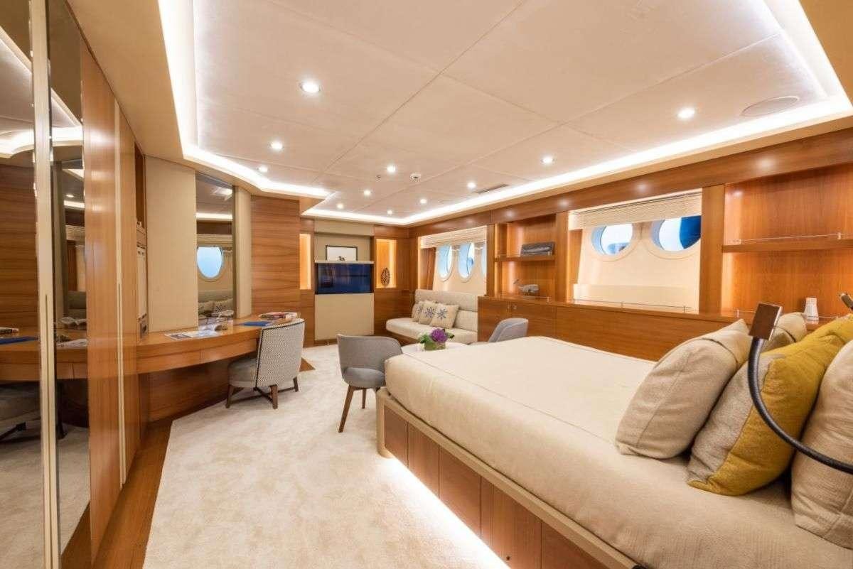 a room with a bed and a desk aboard ARESTEAS Yacht for Charter