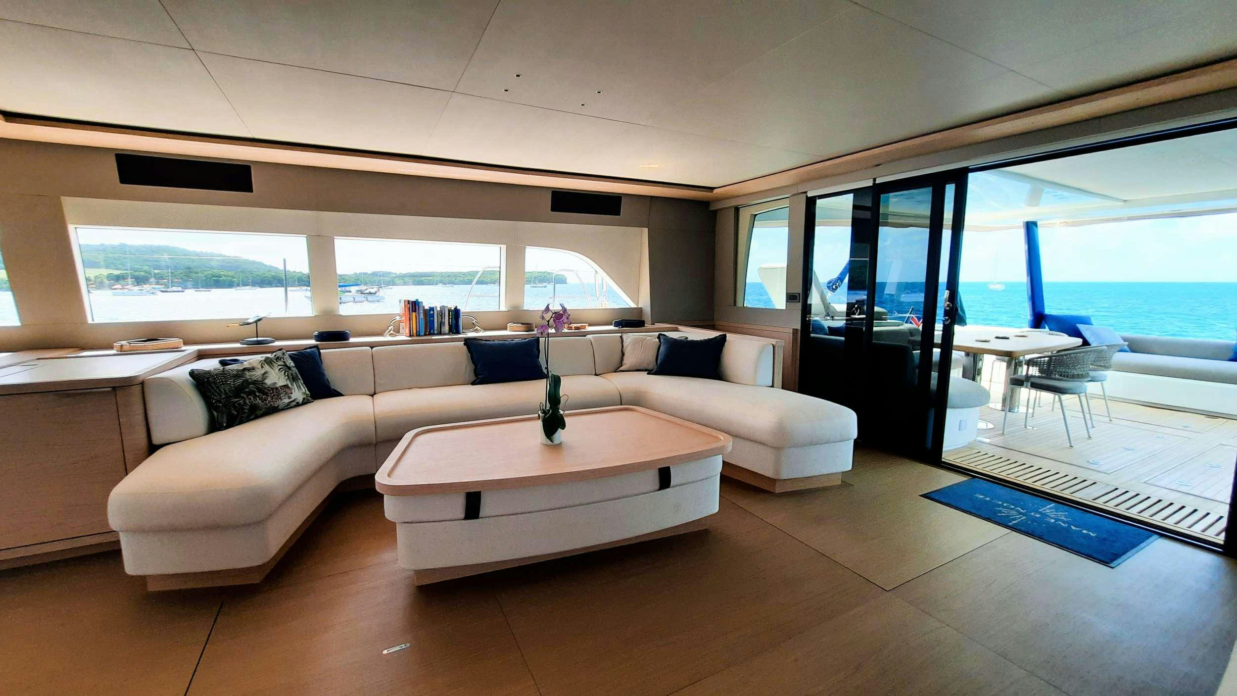 a living room with a couch and a table aboard MANE ET NOCTE Yacht for Charter