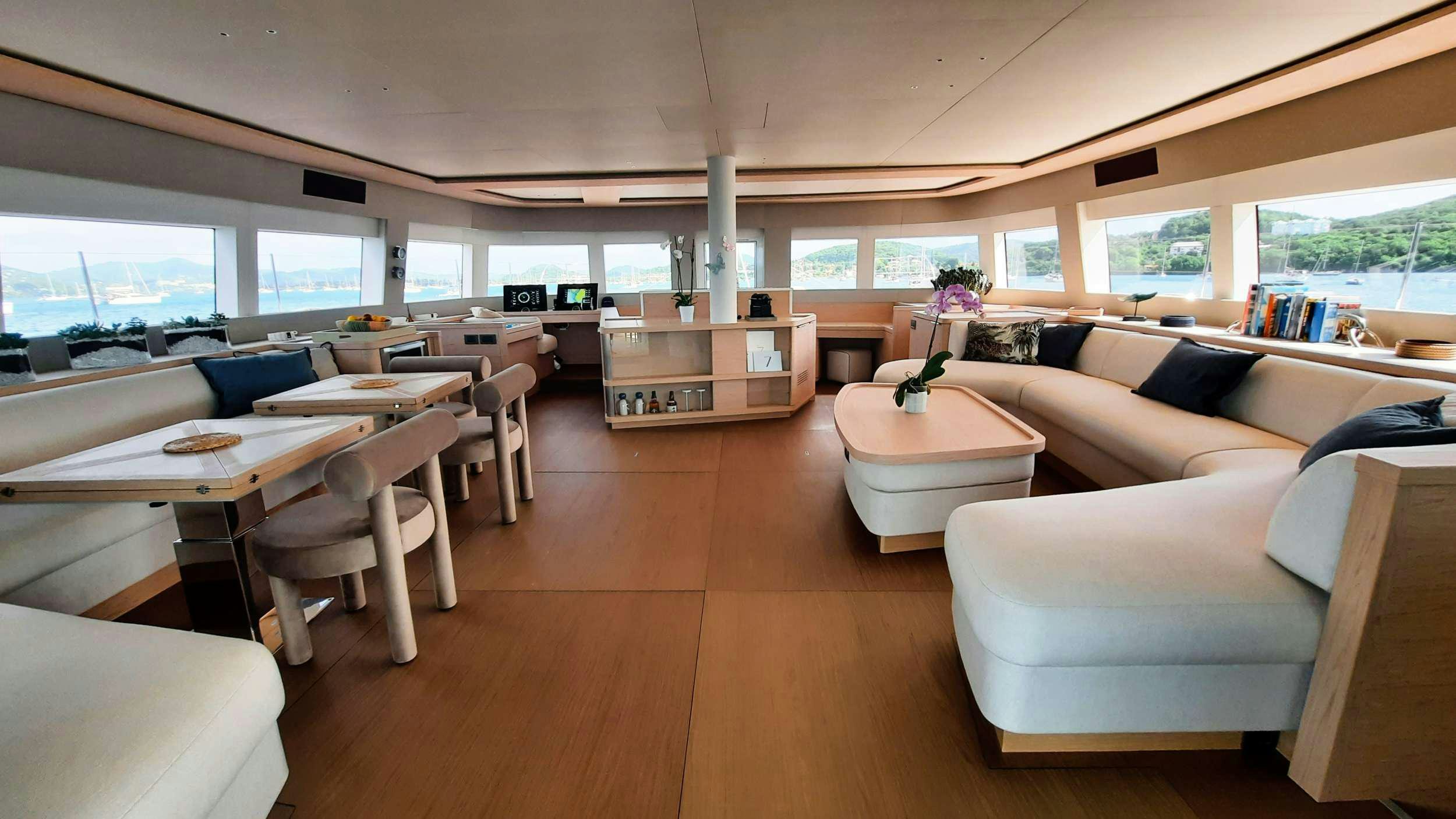 a room with tables and chairs aboard MANE ET NOCTE Yacht for Charter