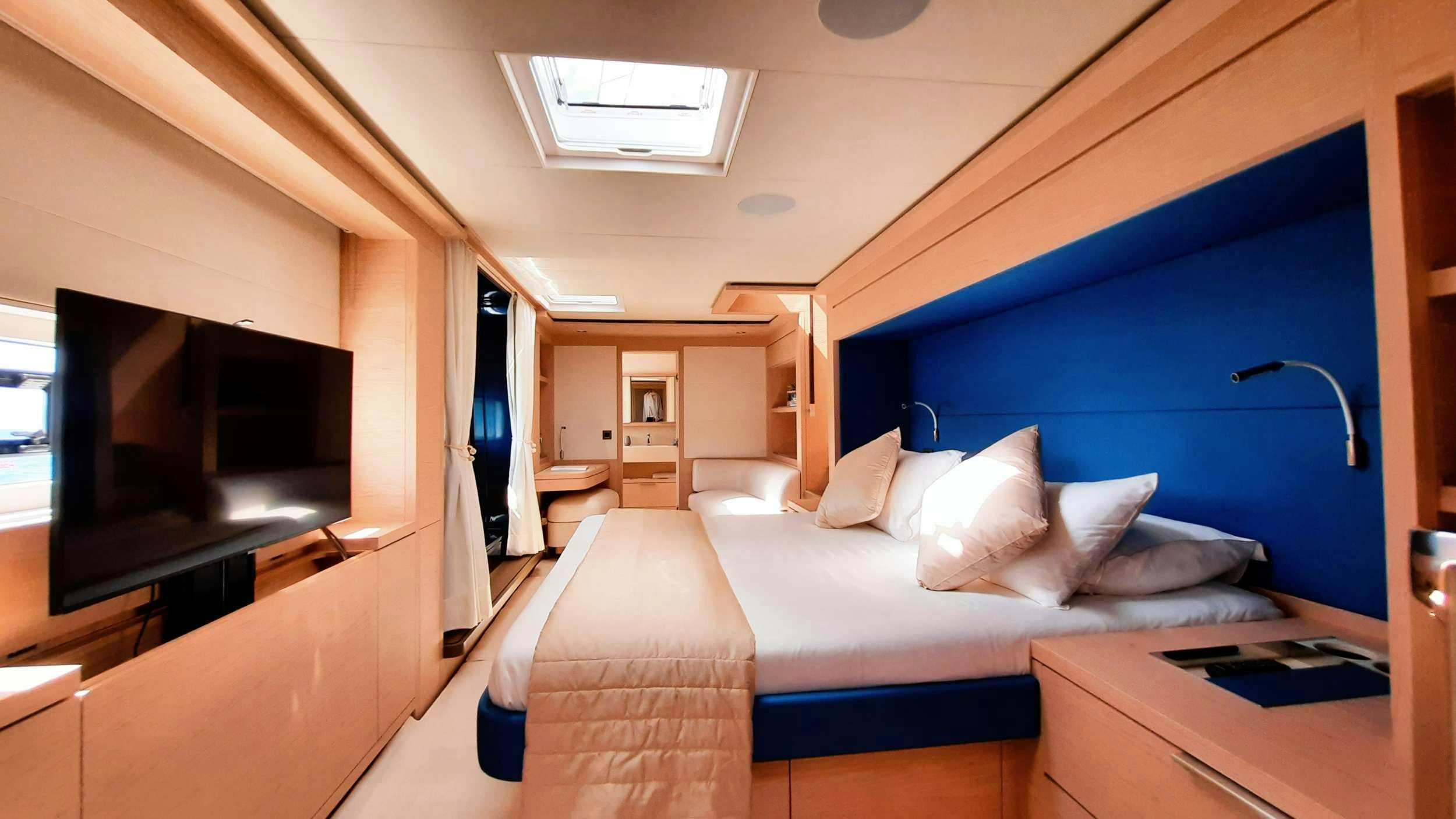 a room with a bed and a tv aboard MANE ET NOCTE Yacht for Charter