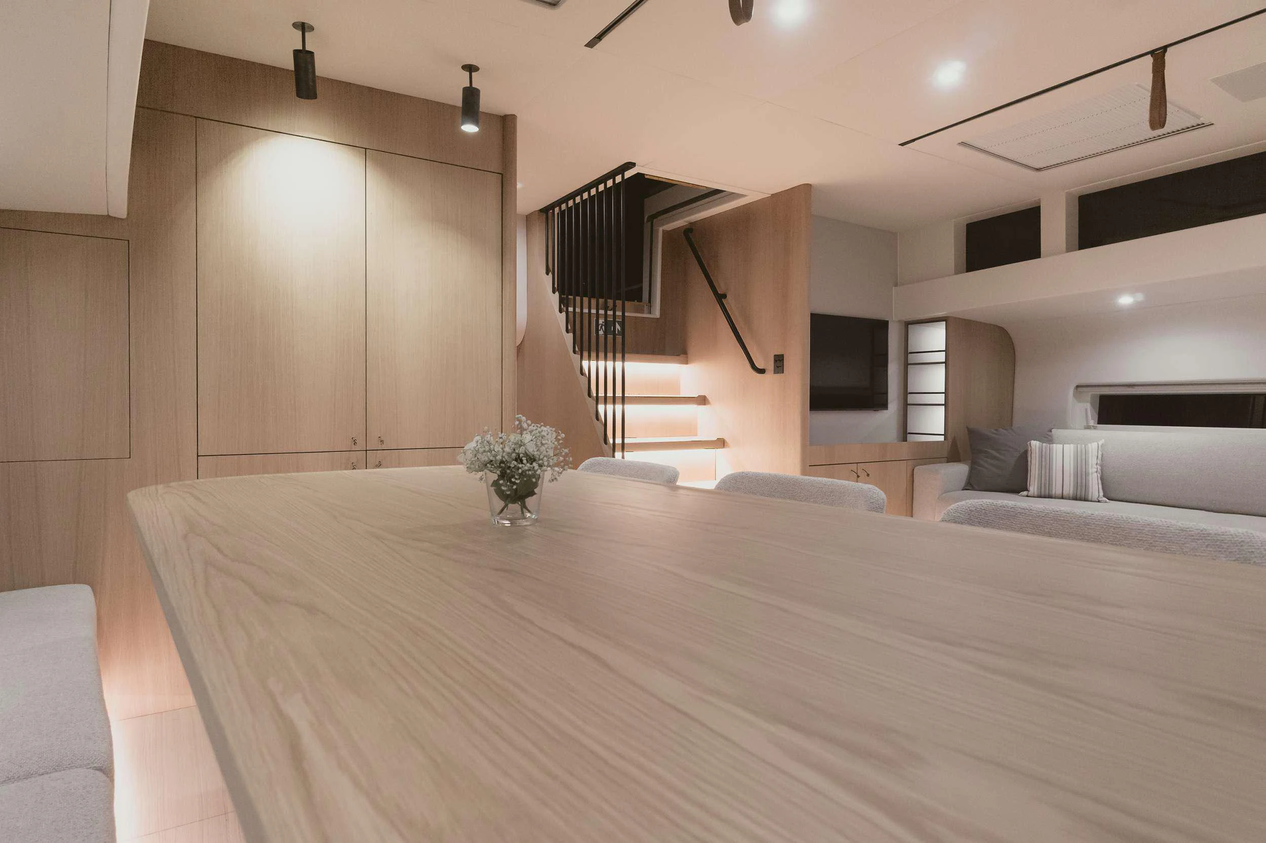 a room with a large bed and a staircase aboard NADAMAS Yacht for Charter
