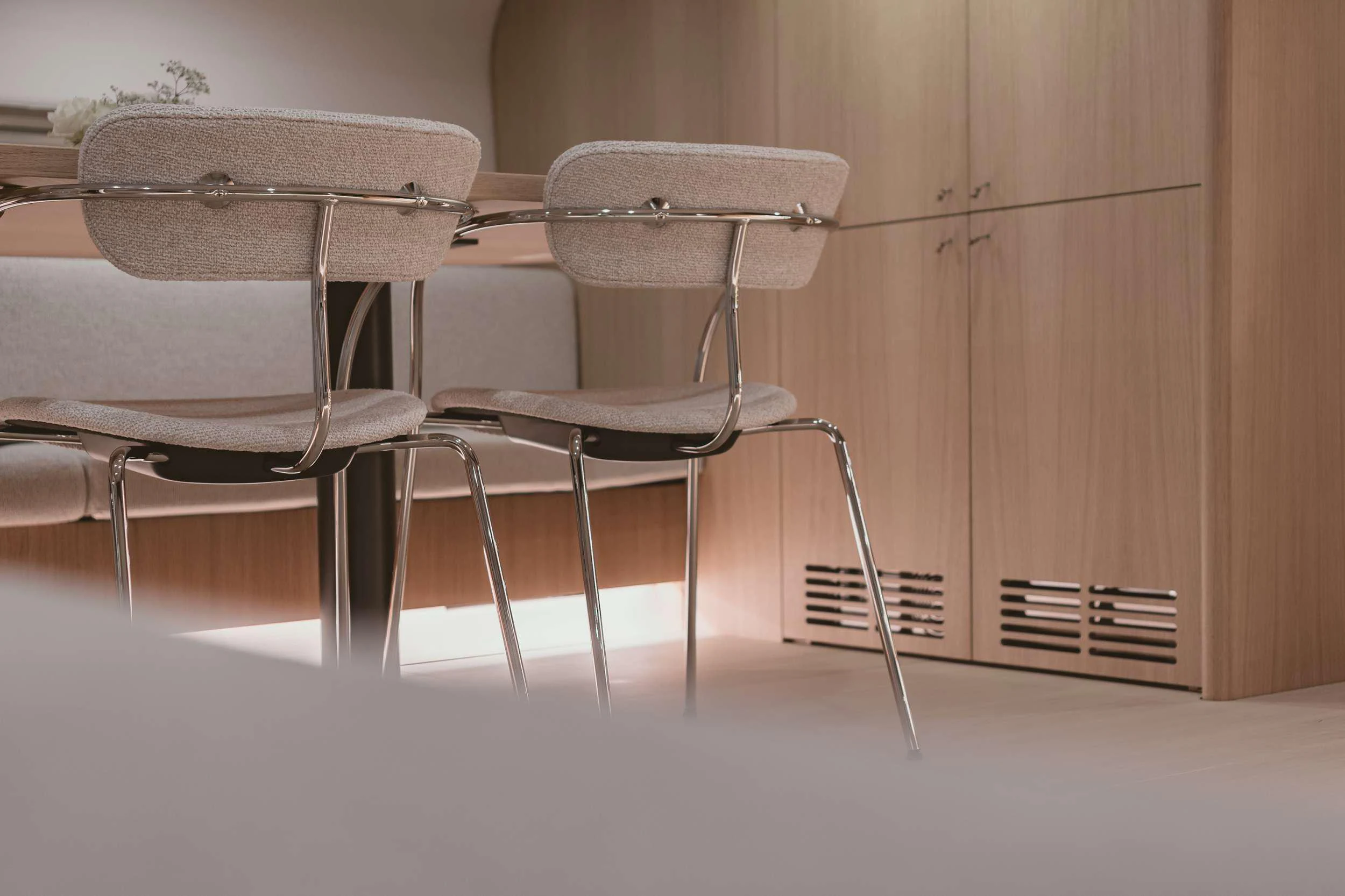 a white chair and a table aboard NADAMAS Yacht for Charter