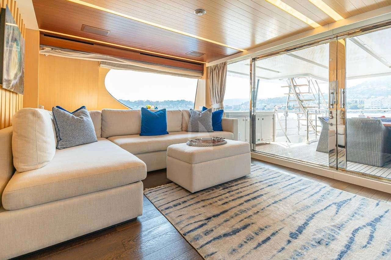 a living room with a large window aboard LULU Yacht for Charter