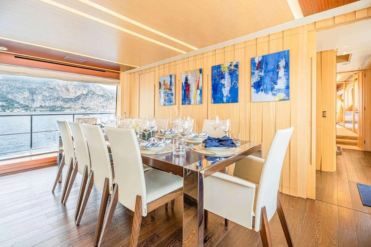 a dining table and chairs on a deck aboard LULU Yacht for Charter