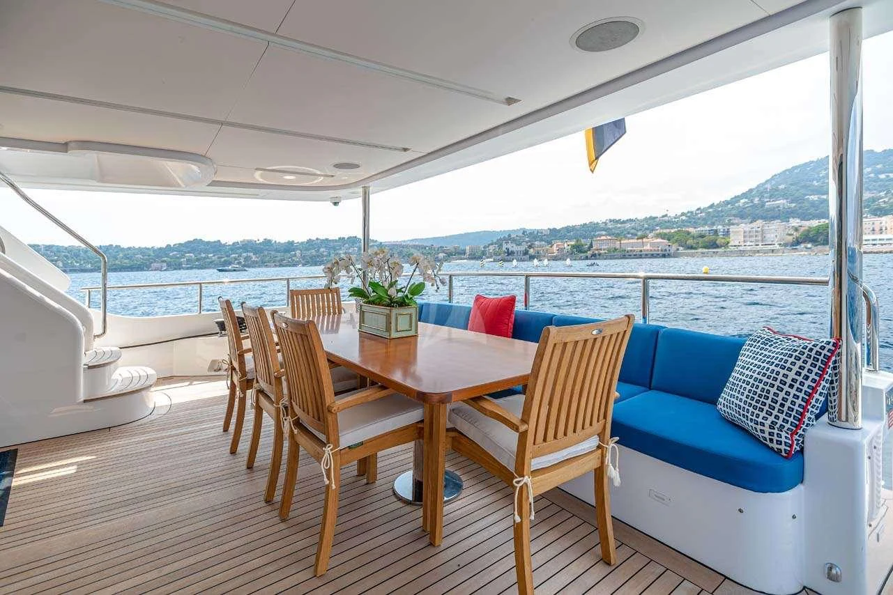 a table and chairs on a boat aboard LULU Yacht for Charter