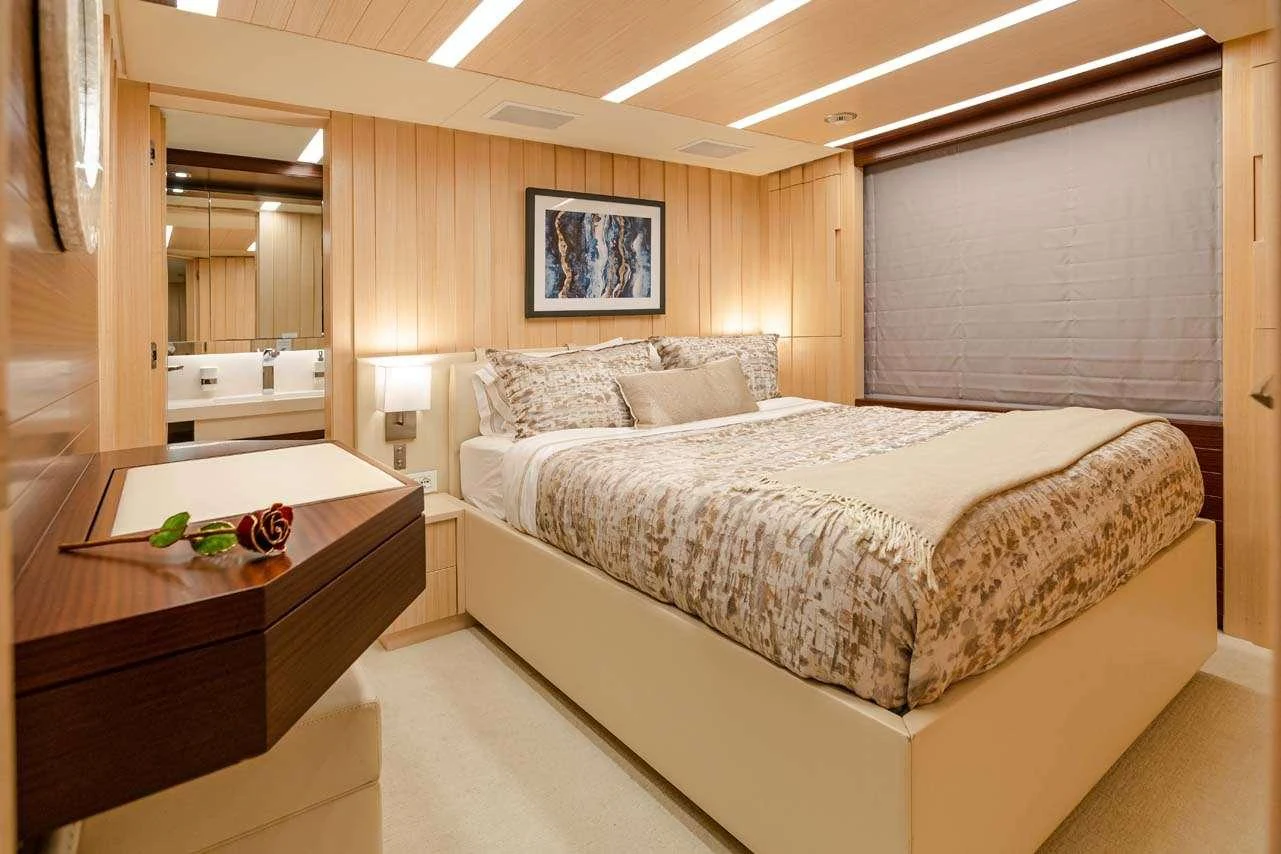 a bedroom with a bed and a desk aboard LULU Yacht for Charter