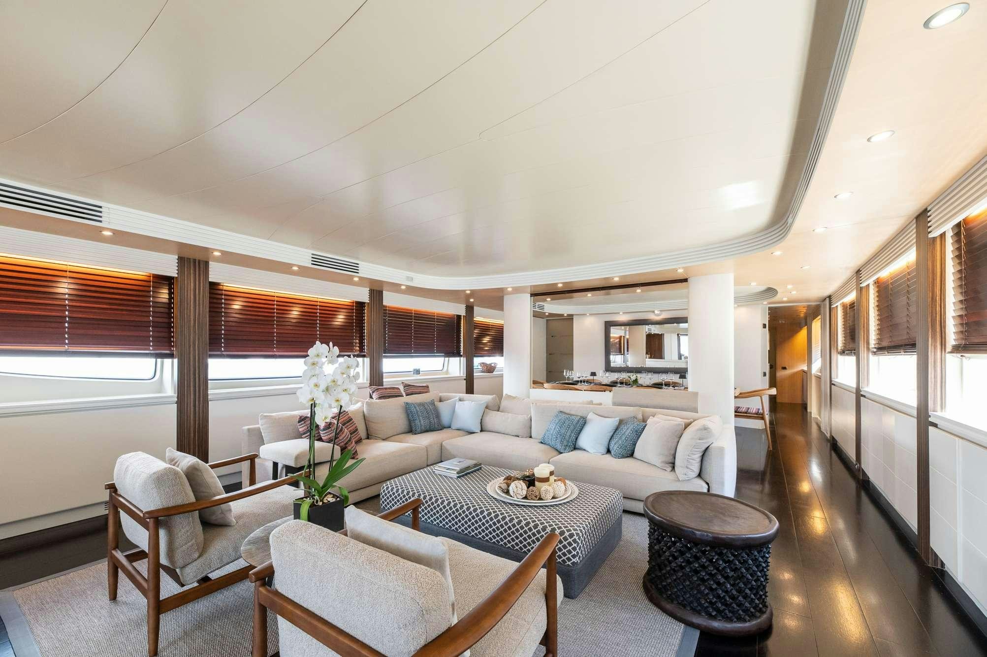 a living room with a couch and a table aboard PEREAKI II Yacht for Charter