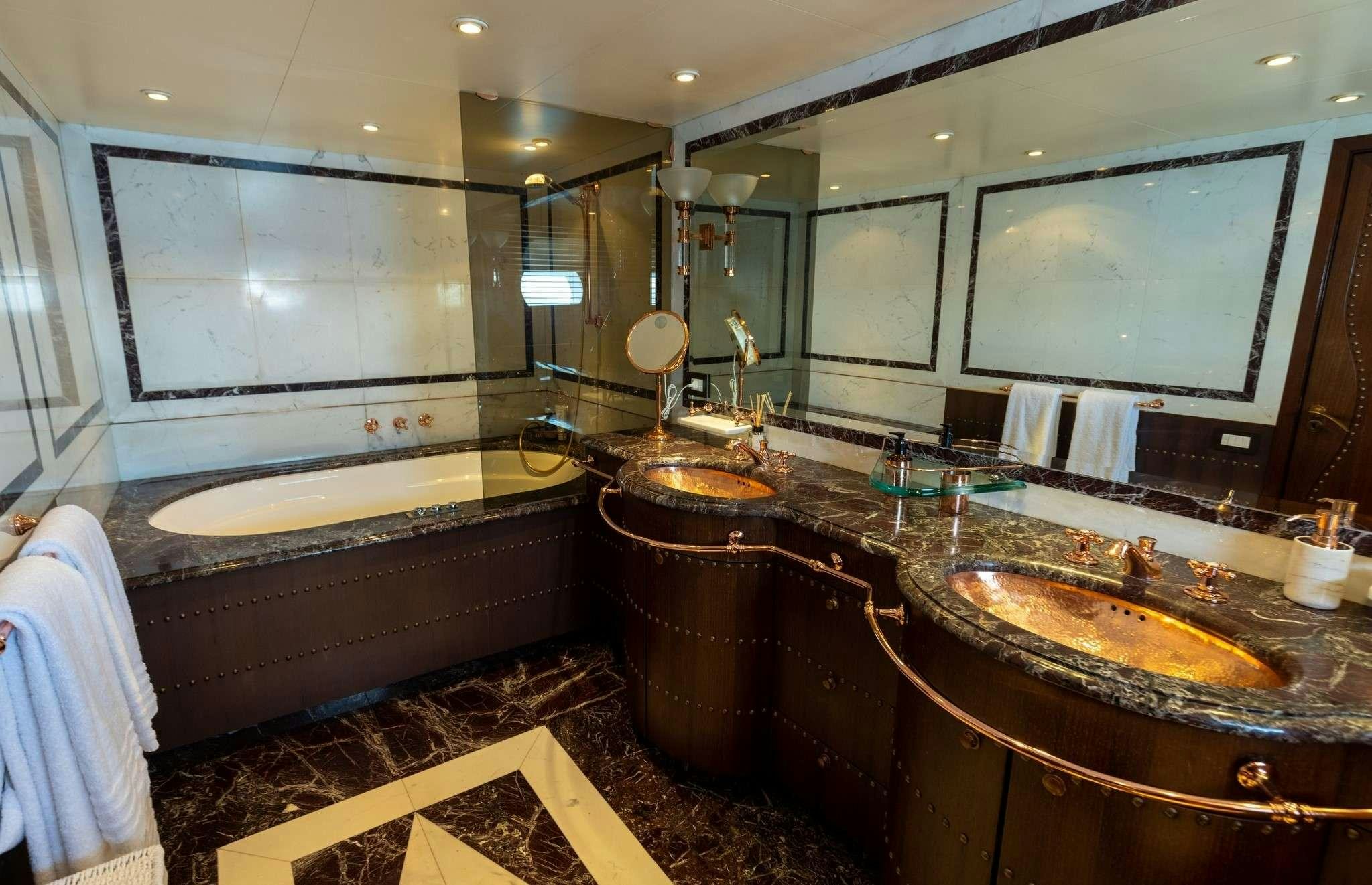 a bathroom with a large mirror aboard MOBIUS Yacht for Charter