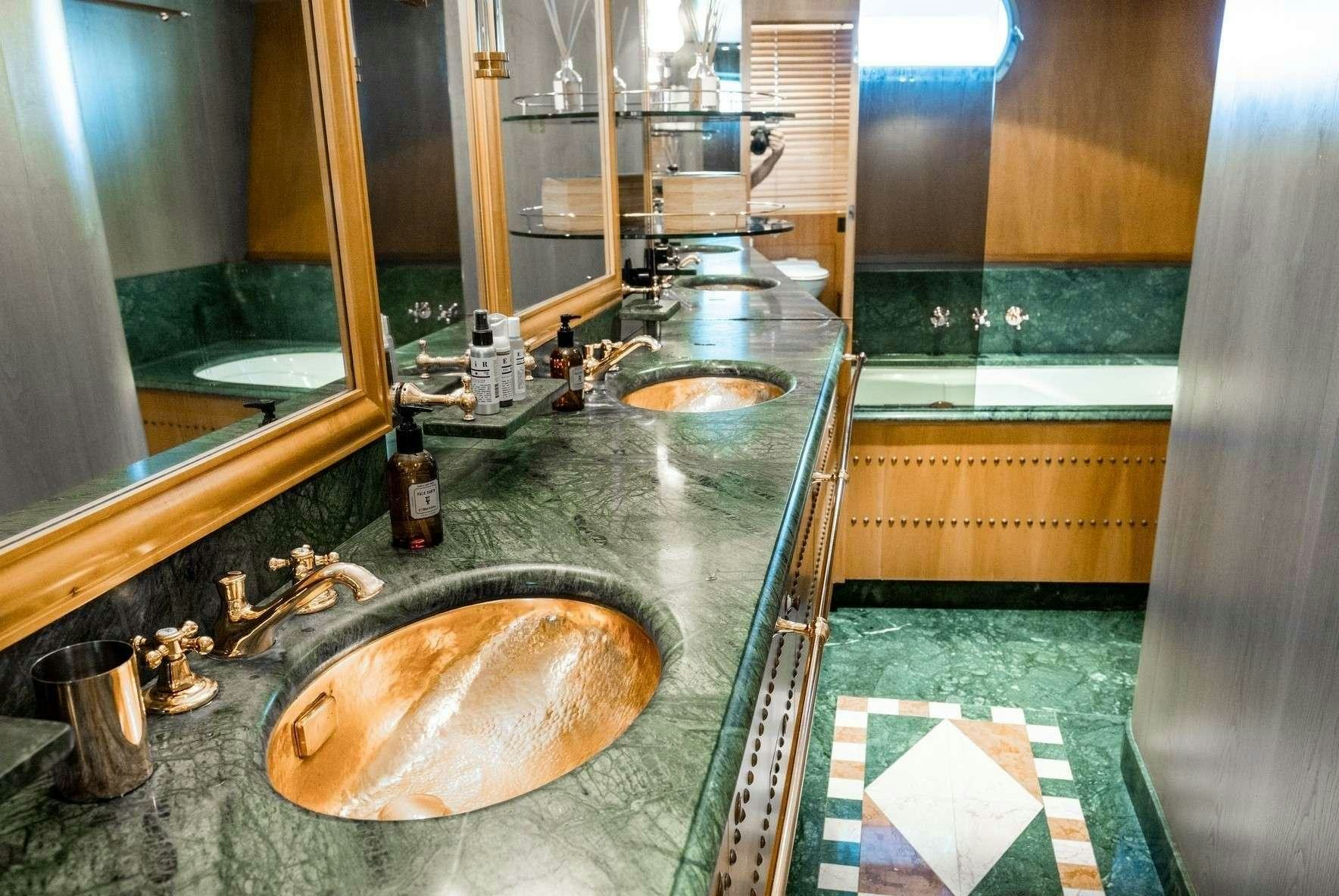 a bathroom with a sink and a mirror aboard MOBIUS Yacht for Charter