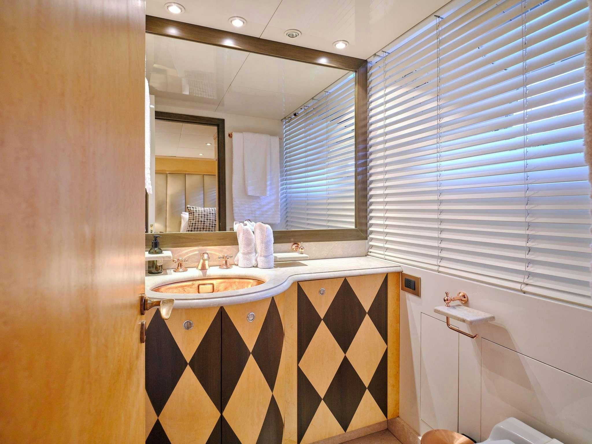 a bathroom with a sink and a mirror aboard MOBIUS Yacht for Charter