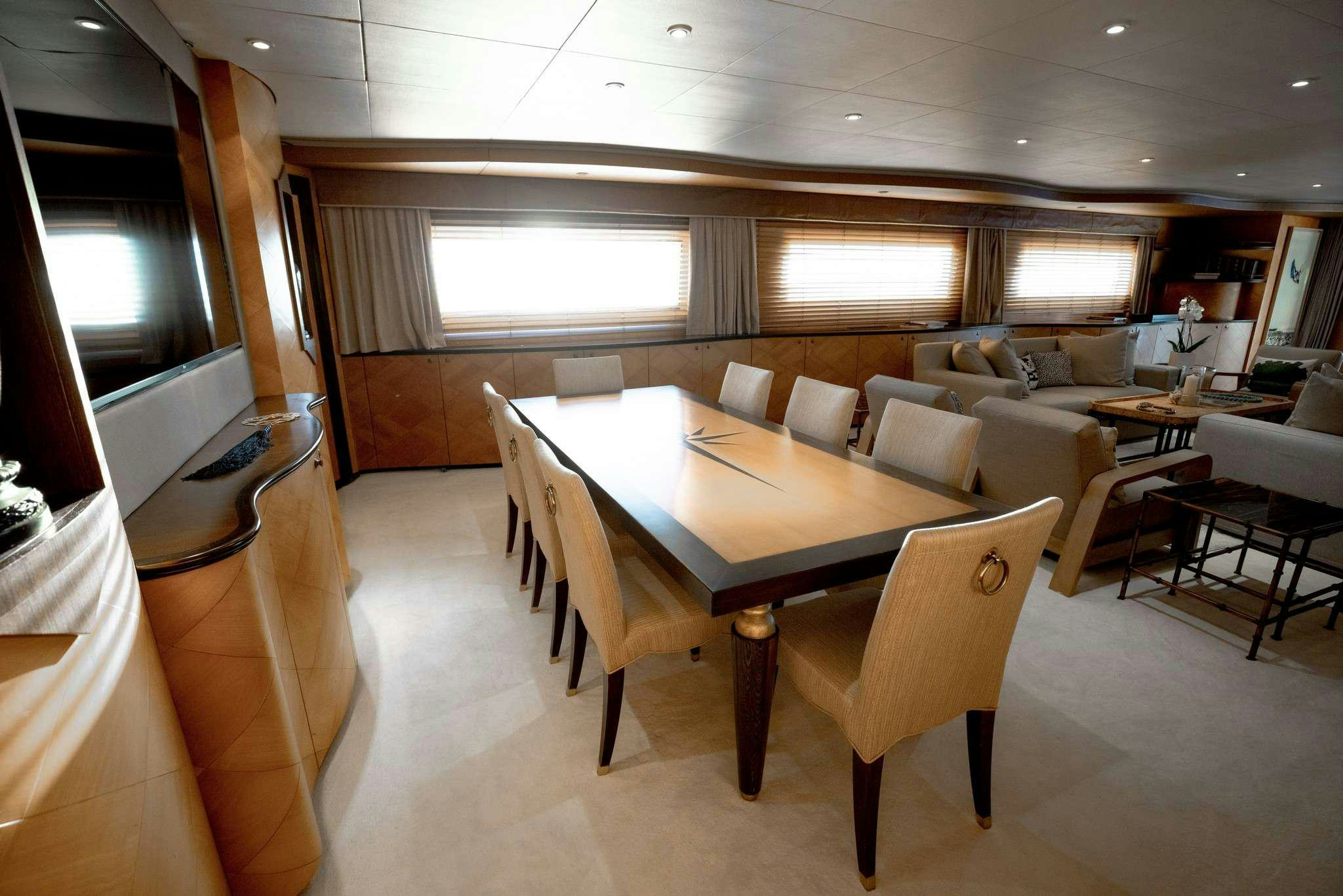a room with a table and chairs aboard MOBIUS Yacht for Charter