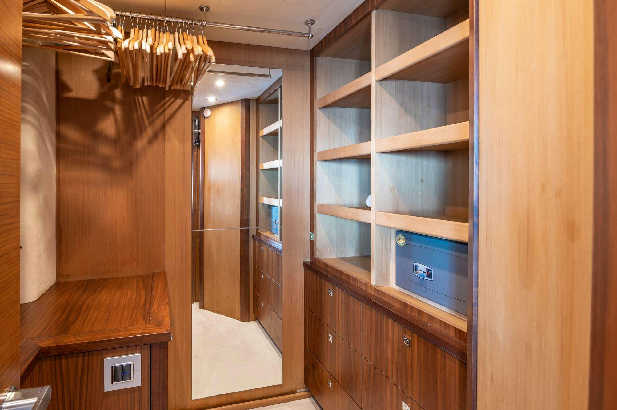 a room with a cabinet and a shelf with a mirror aboard BLADE 6 Yacht for Charter