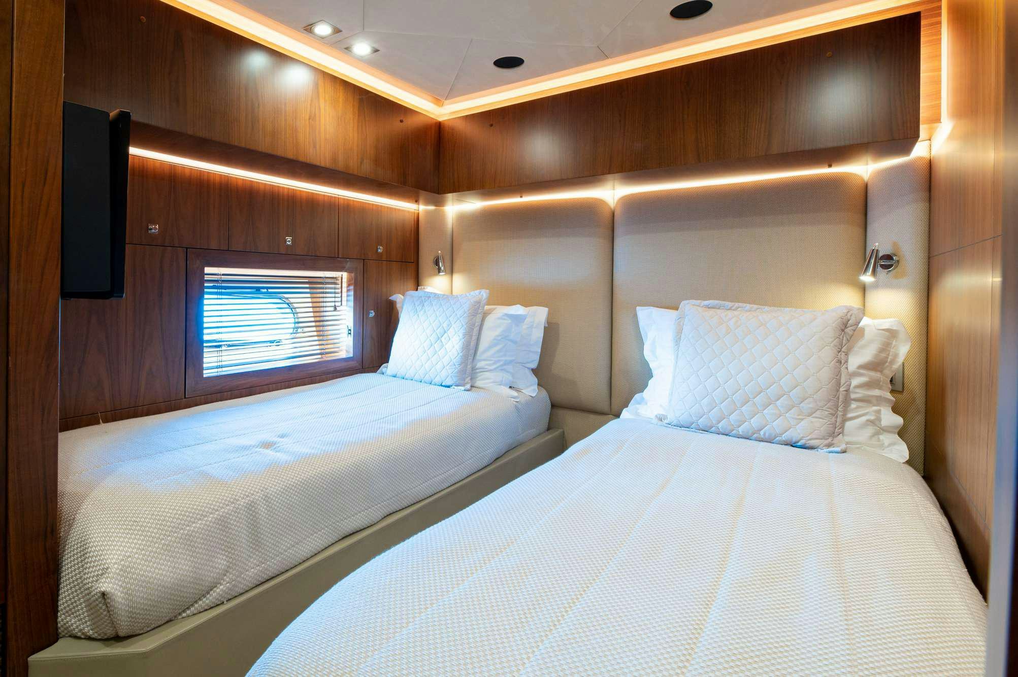 a couple of beds in a room aboard BLADE 6 Yacht for Charter