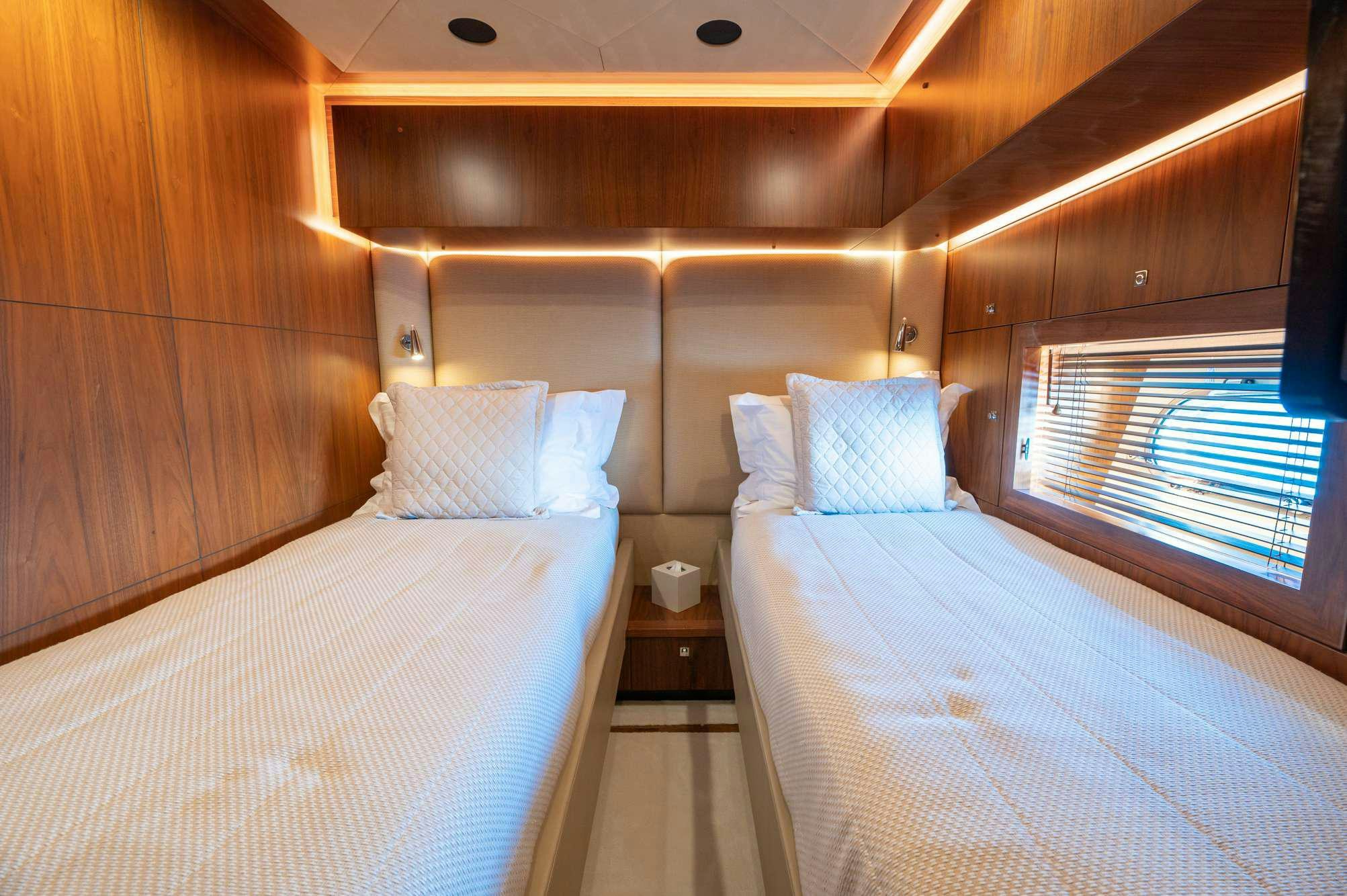 a room with a bed and a window aboard BLADE 6 Yacht for Charter