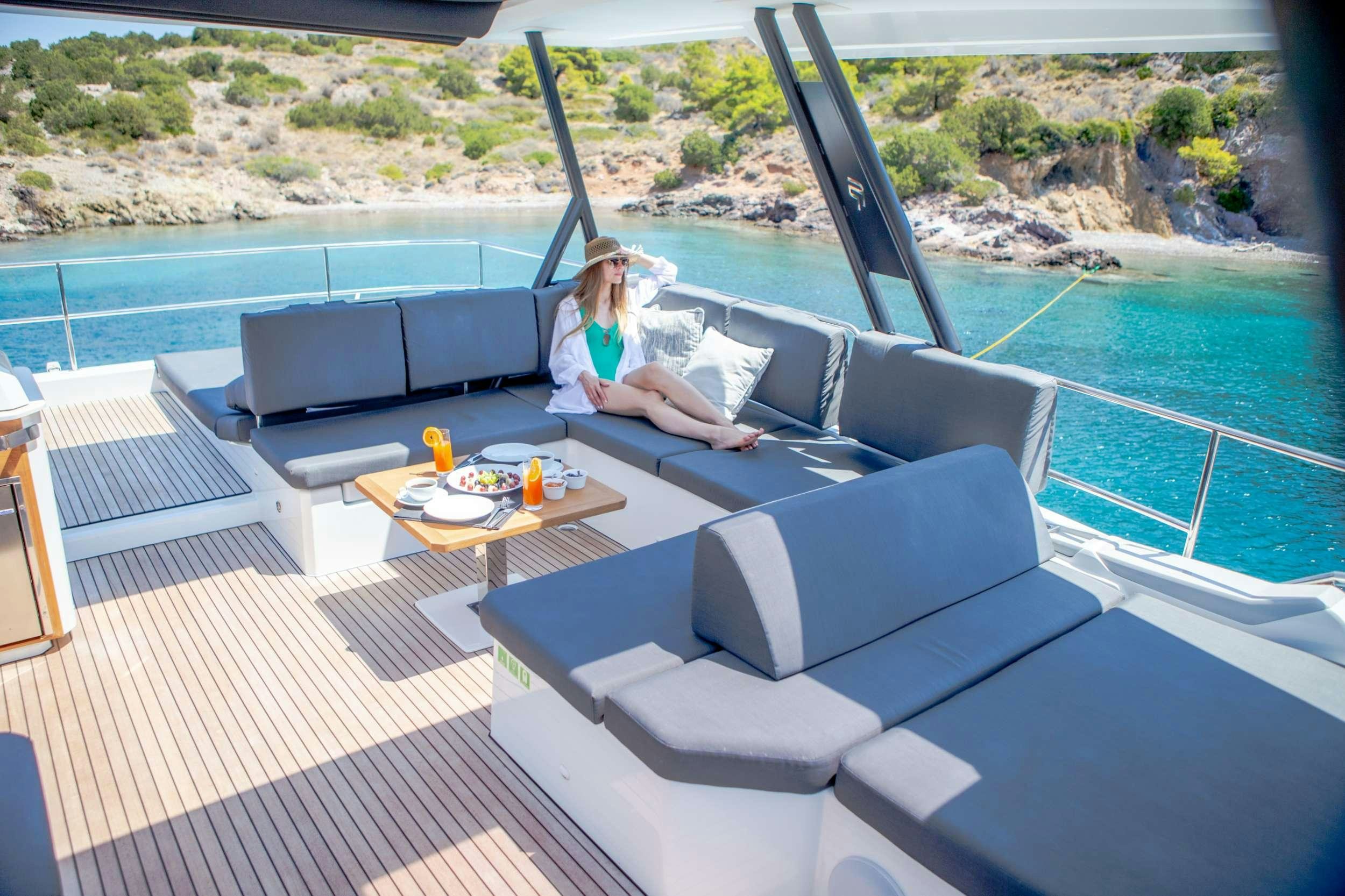 a person sitting on a couch aboard ELLY Yacht for Charter