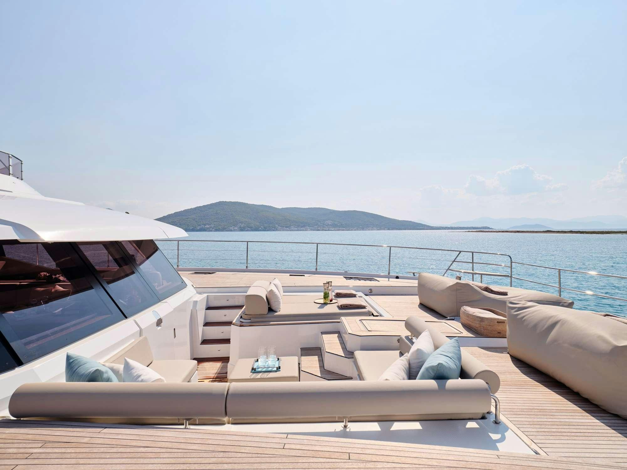 a lounge area with a table and chairs on it aboard ELLY Yacht for Charter