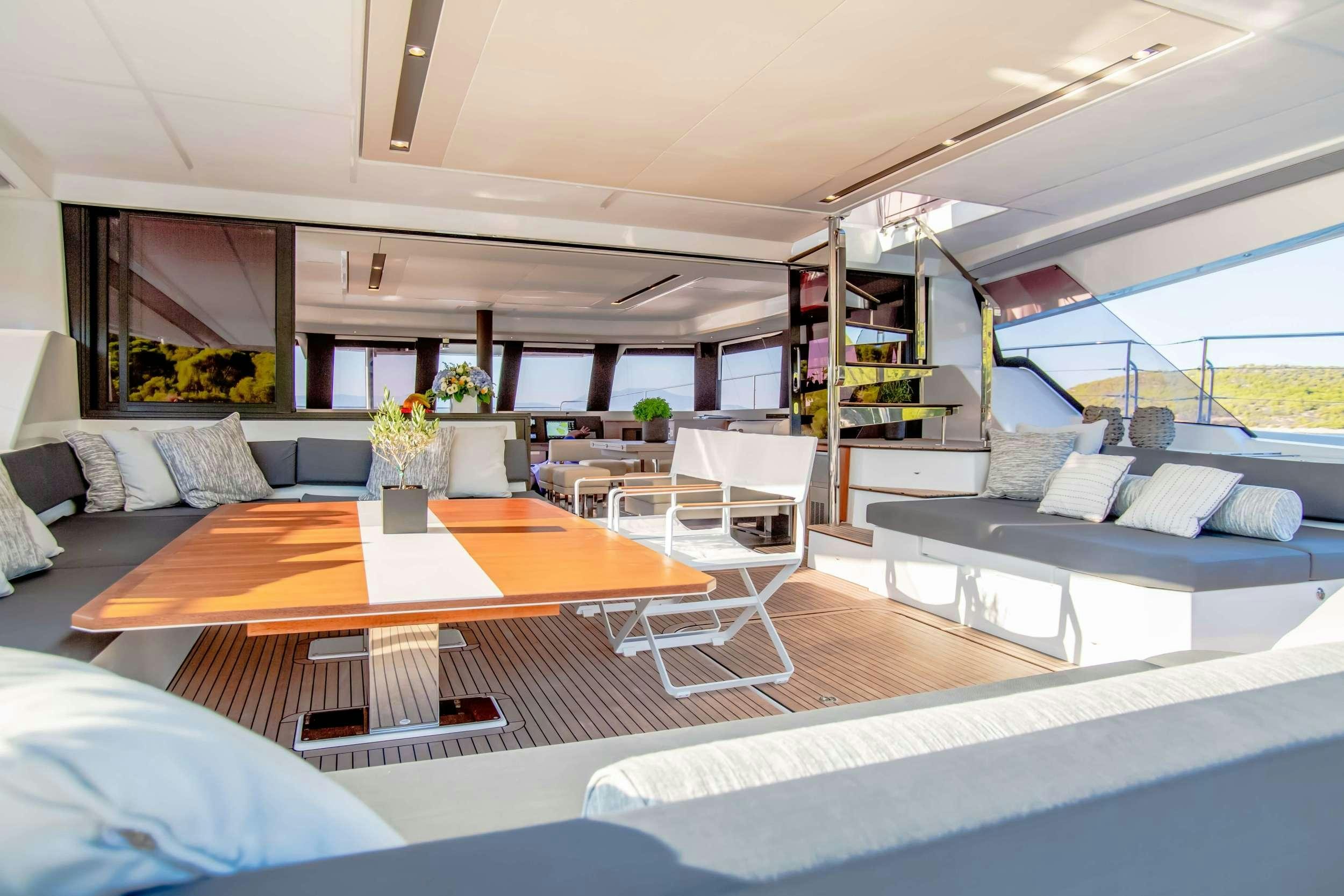 a room with a couch and a table and a bed aboard ELLY Yacht for Charter