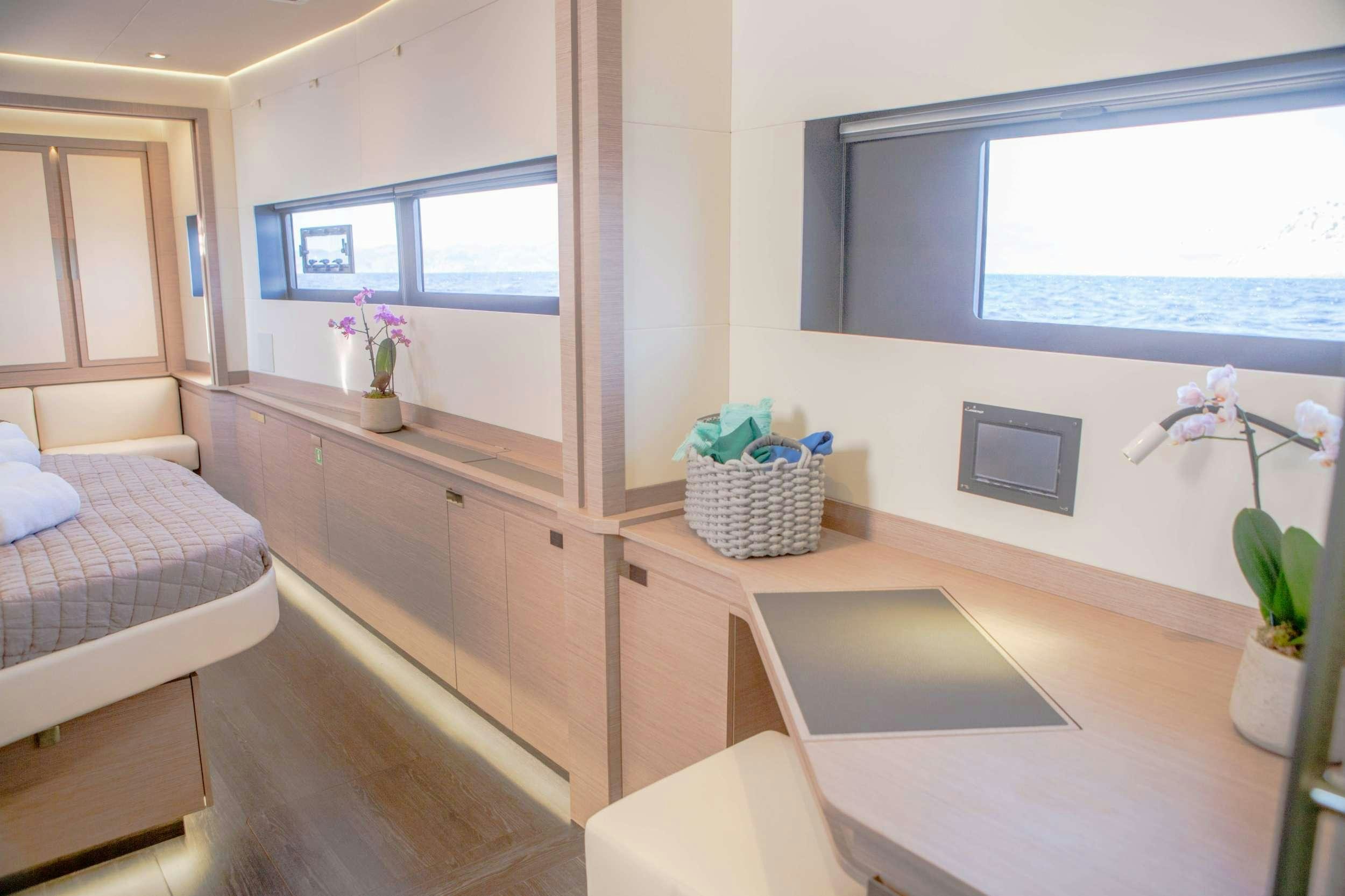 a room with a bed and a desk aboard ELLY Yacht for Charter