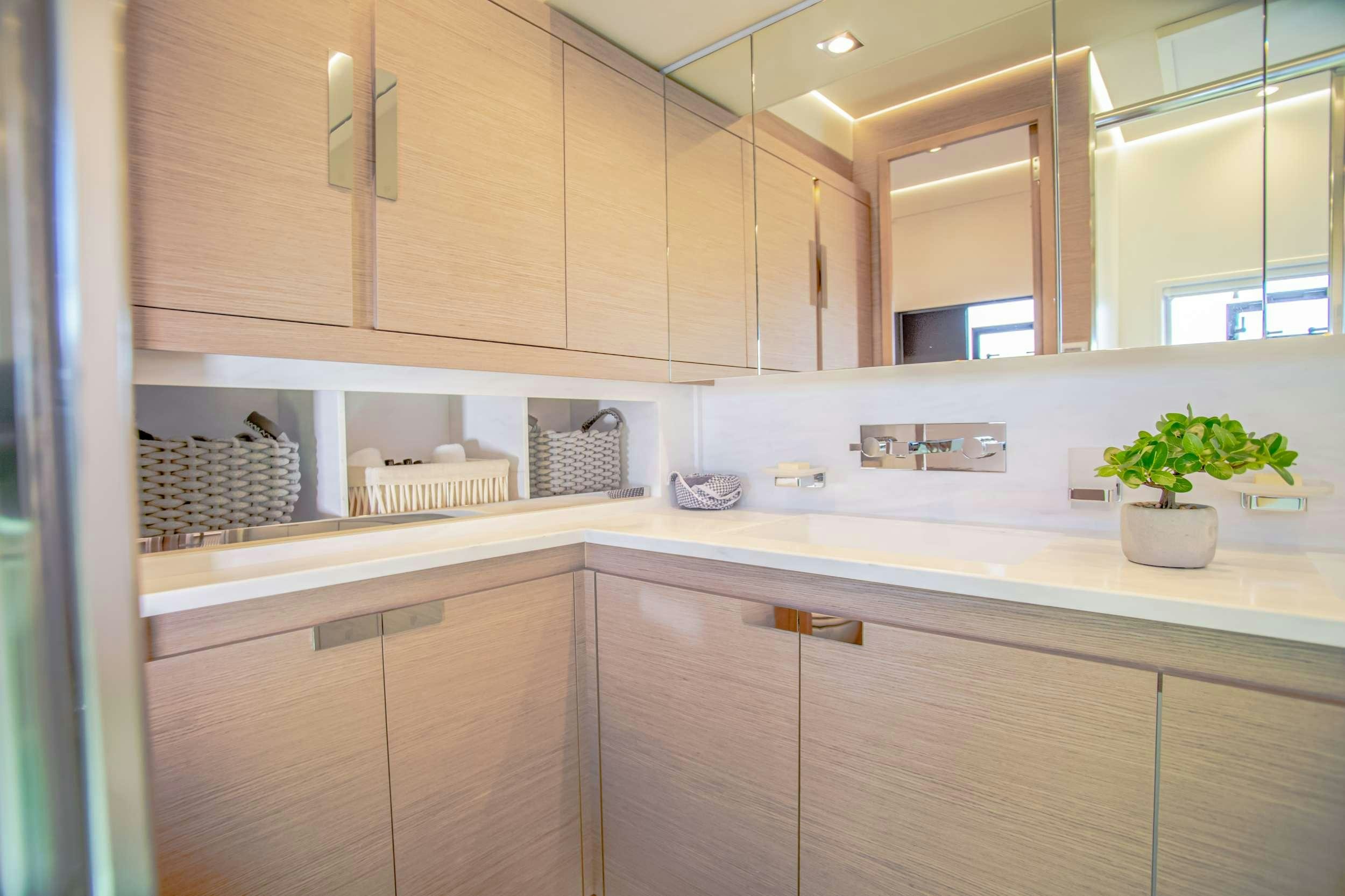 a kitchen with white cabinets aboard ELLY Yacht for Charter