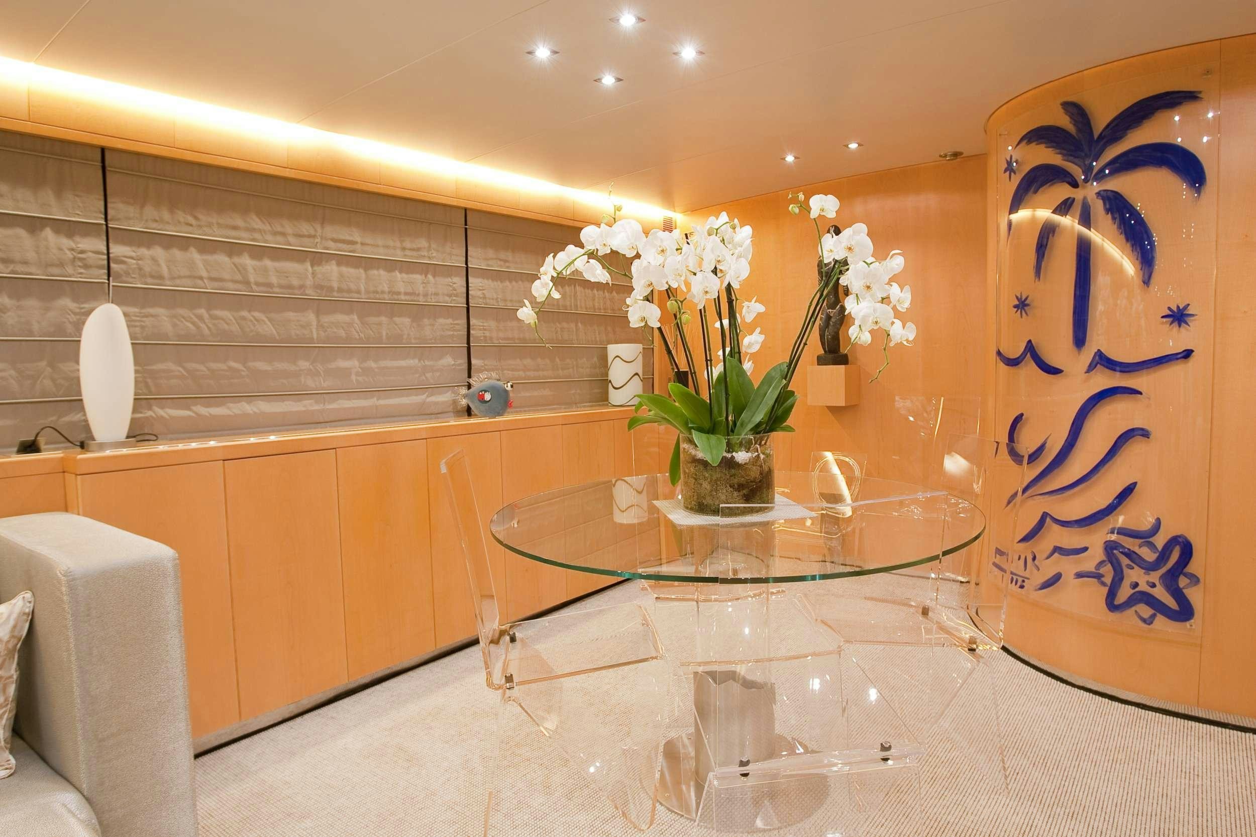 a vase of flowers on a table aboard COCA VI Yacht for Charter