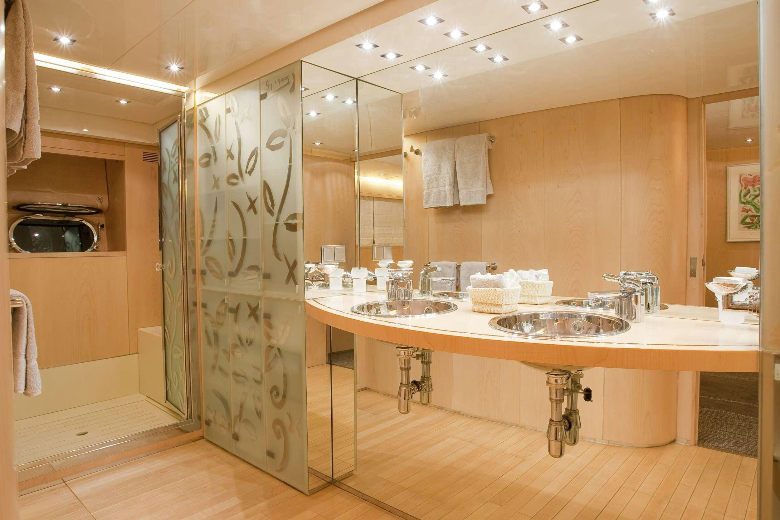 a bathroom with a sink and a mirror aboard COCA VI Yacht for Charter