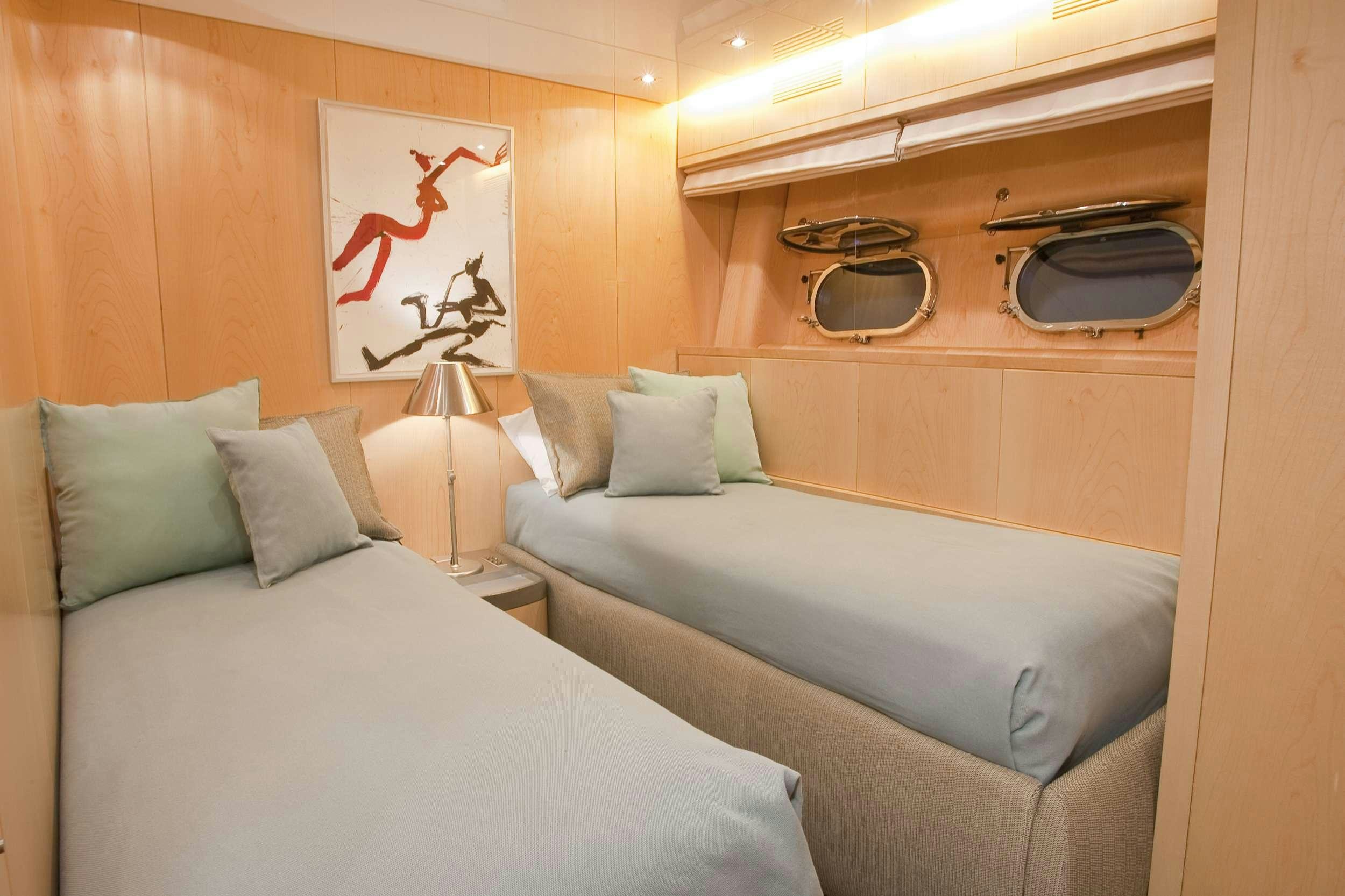 a bedroom with a bed and a television aboard COCA VI Yacht for Charter