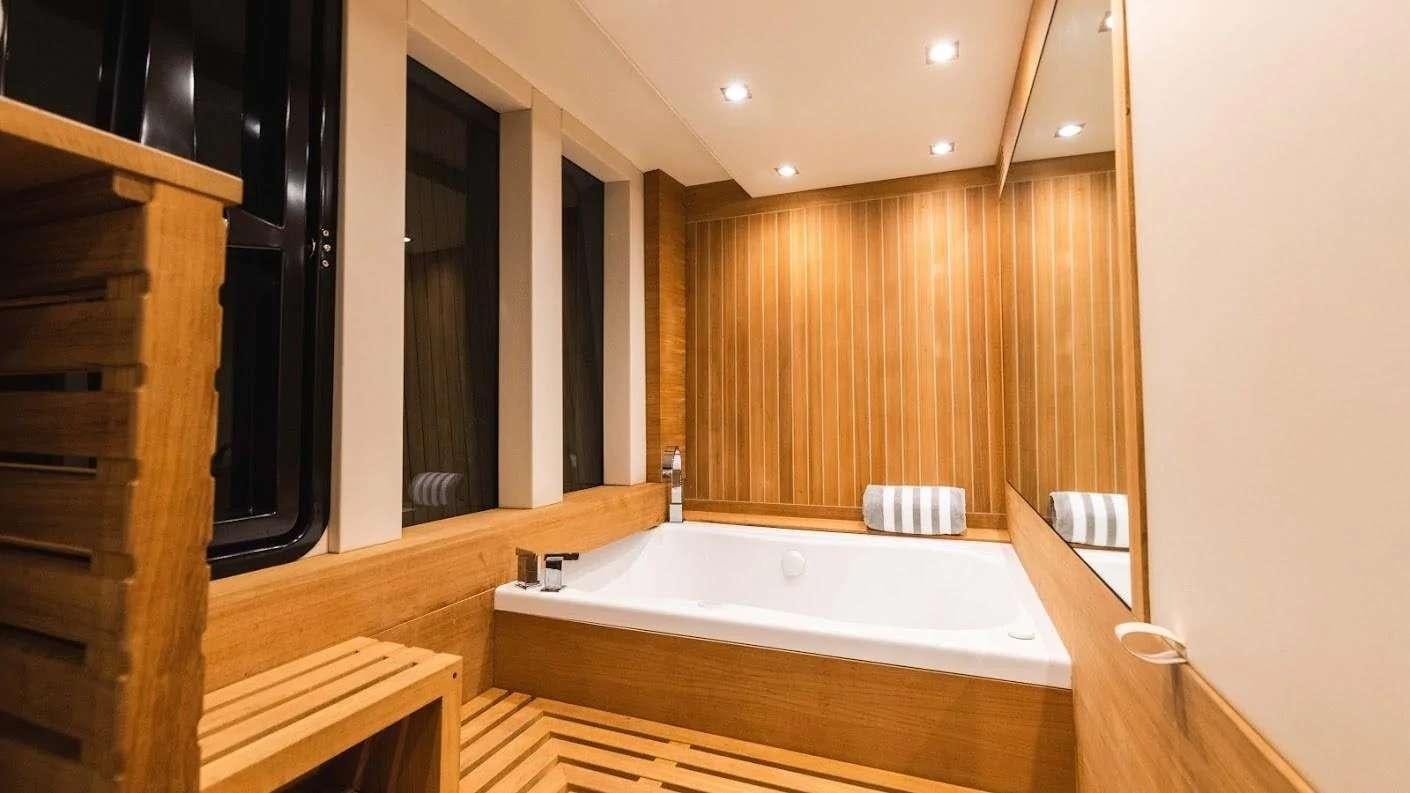 a bathroom with a large bathtub aboard NEW LIFE Yacht for Charter