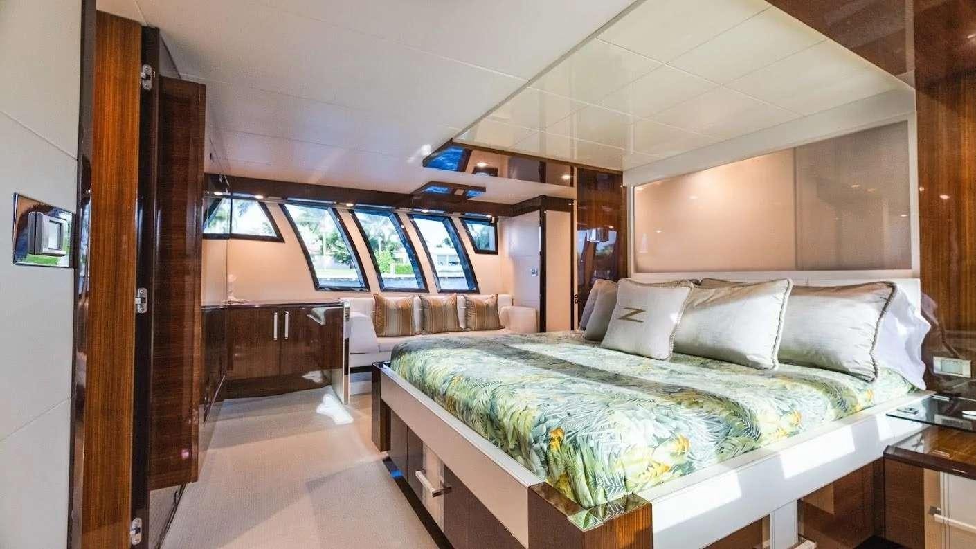 a room with a bed and a desk aboard NEW LIFE Yacht for Charter