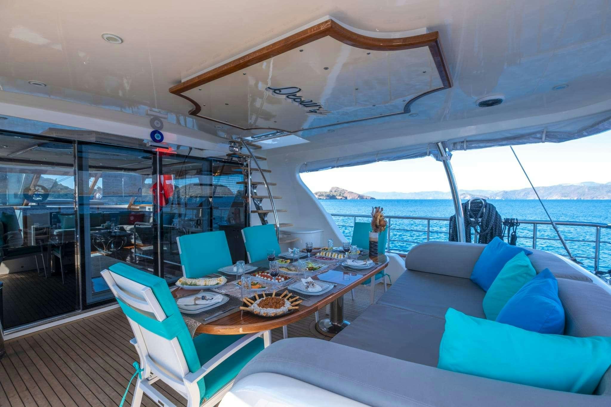 a boat with a table and chairs aboard DESTINY Yacht for Charter