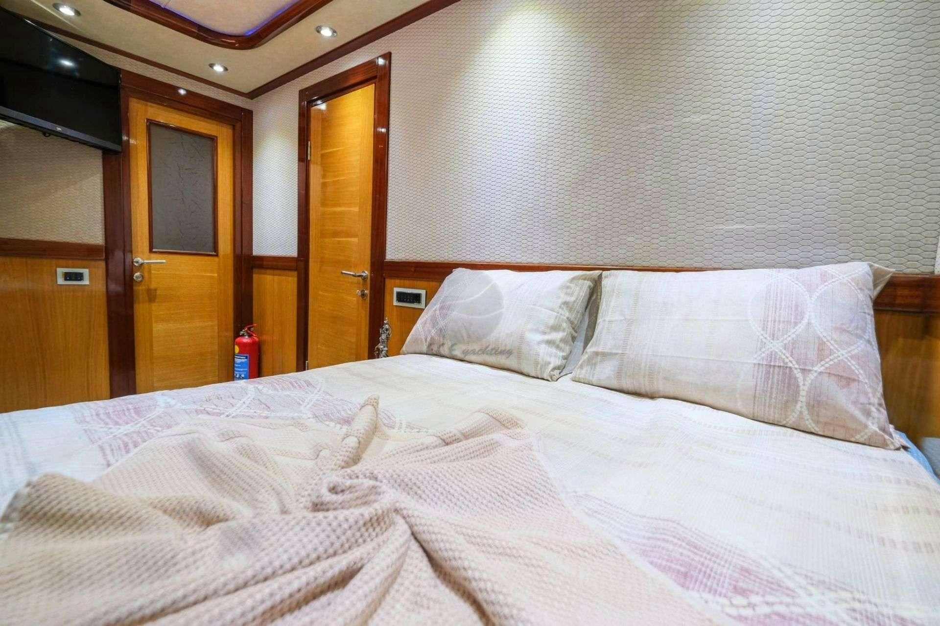a bed with white sheets aboard DESTINY Yacht for Charter
