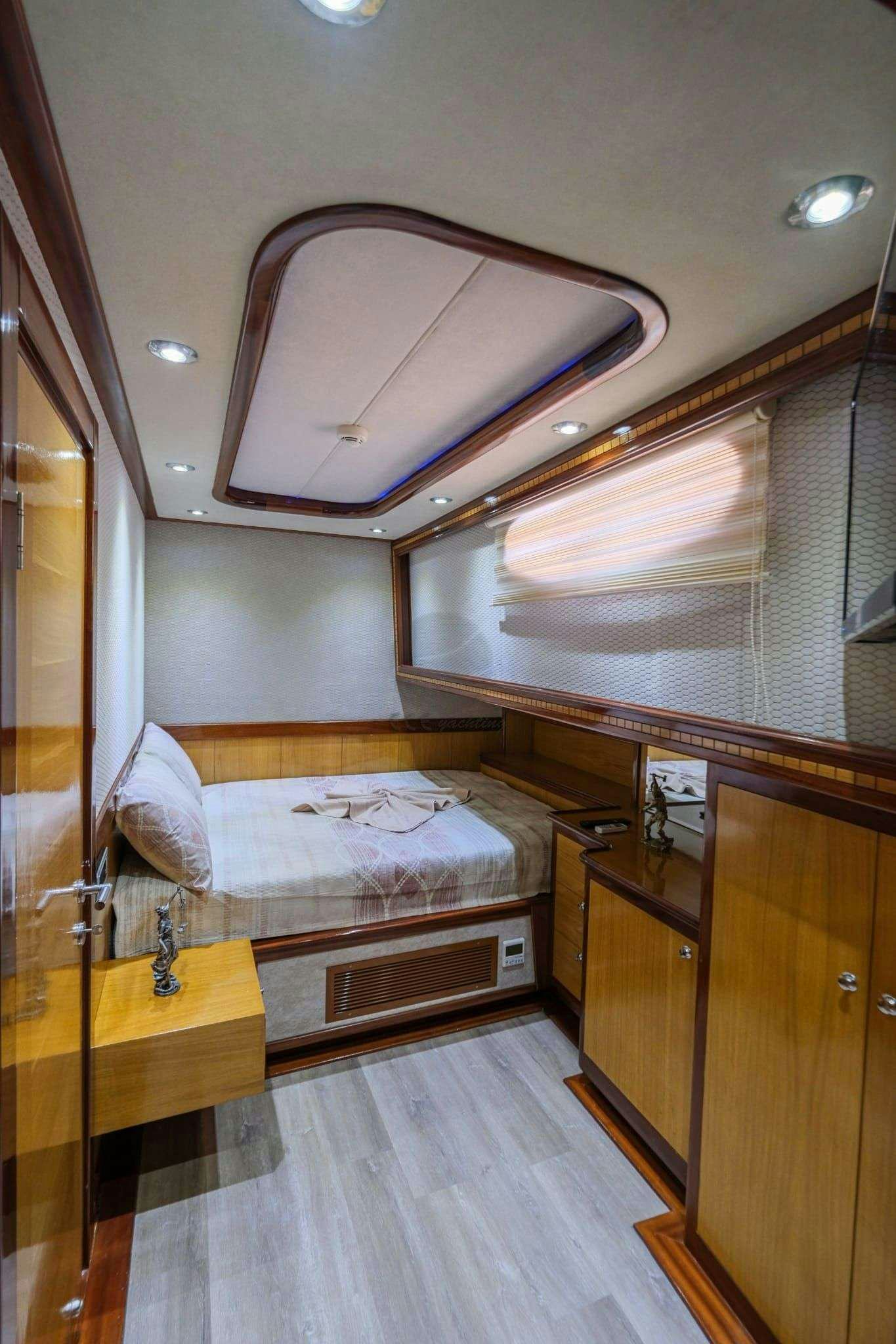 a bathroom with a bed and a sink aboard DESTINY Yacht for Charter