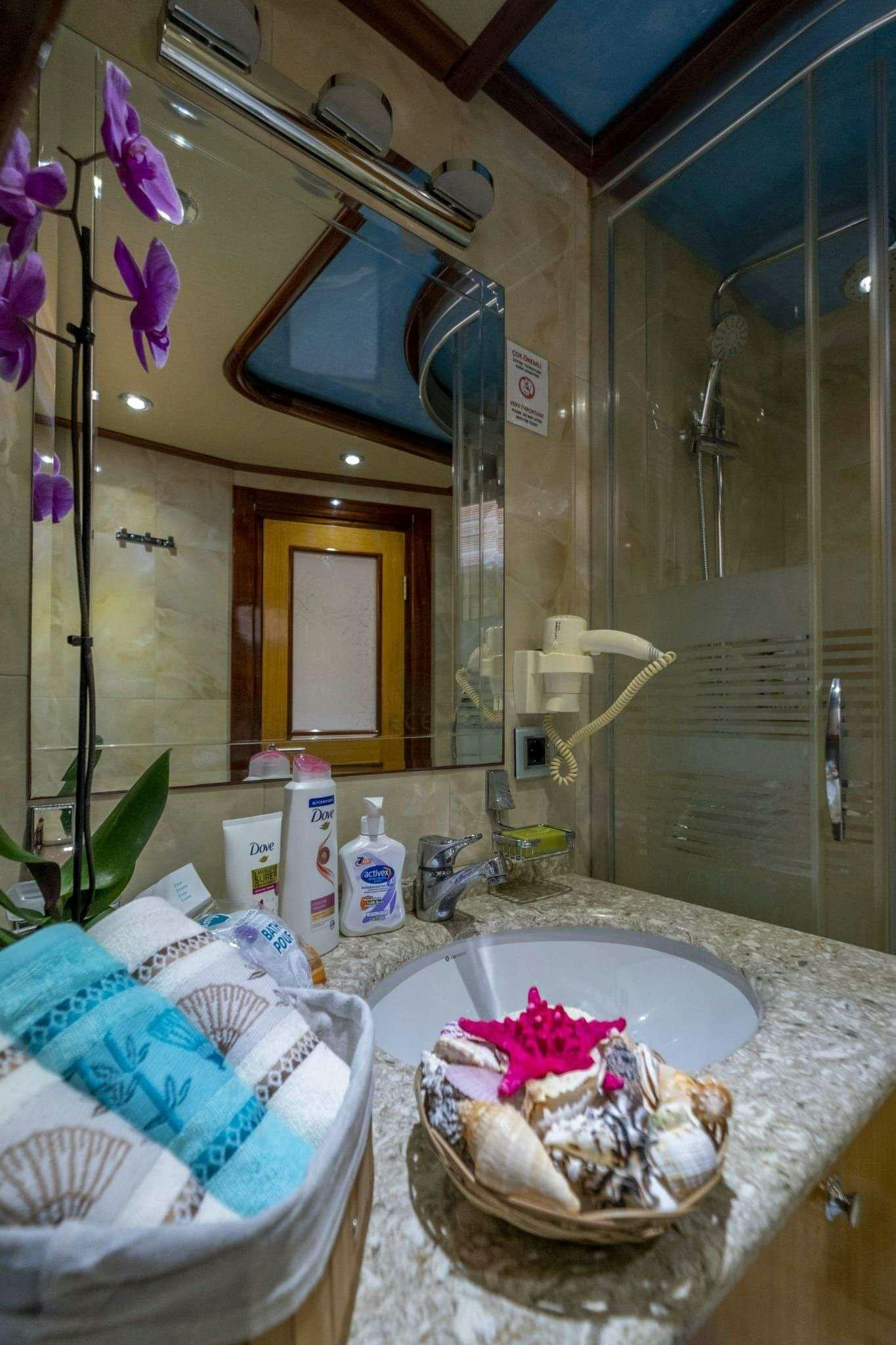 a bathroom with a large mirror aboard DESTINY Yacht for Charter