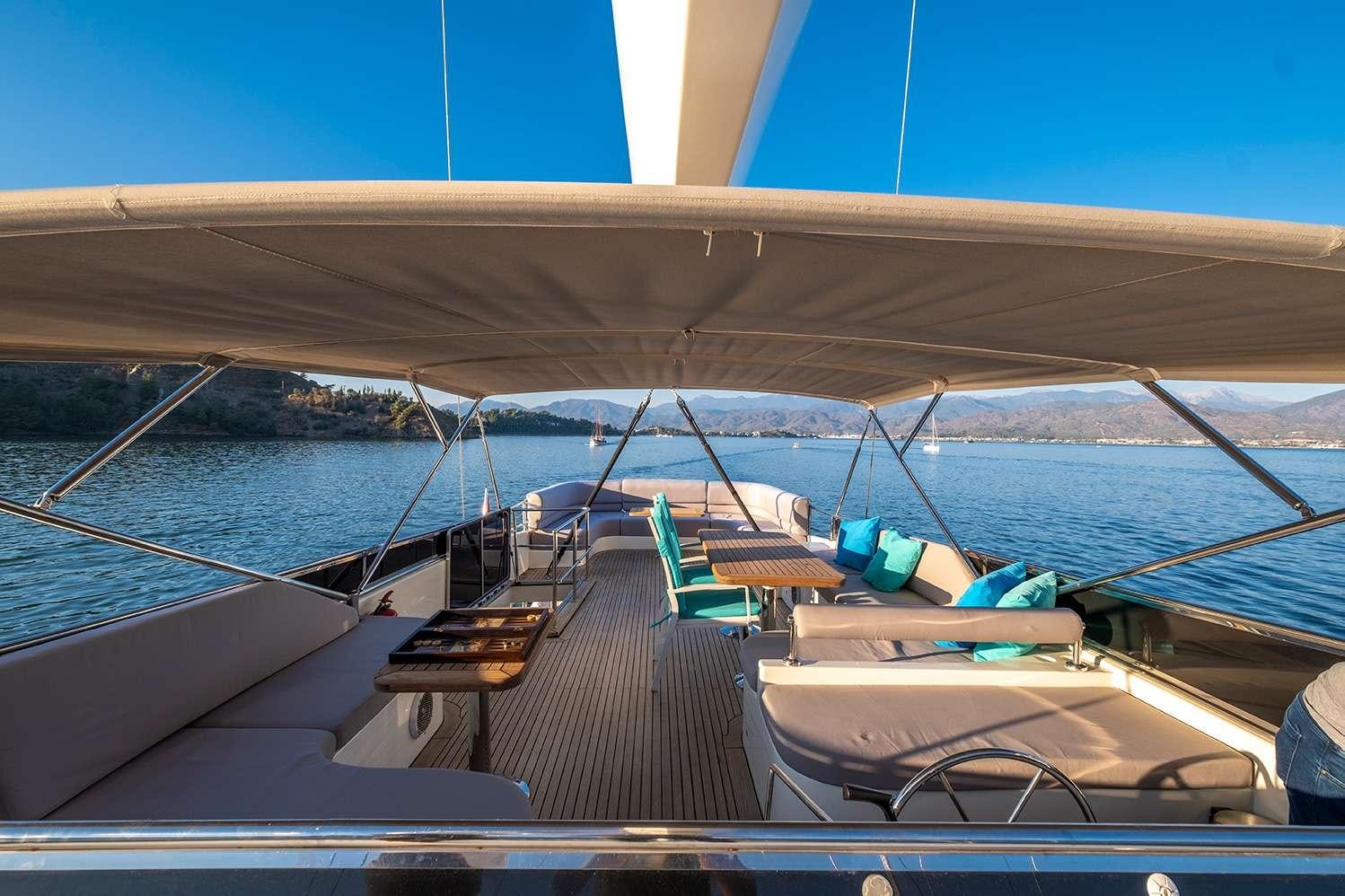 a deck with a boat and chairs on it aboard DESTINY Yacht for Charter
