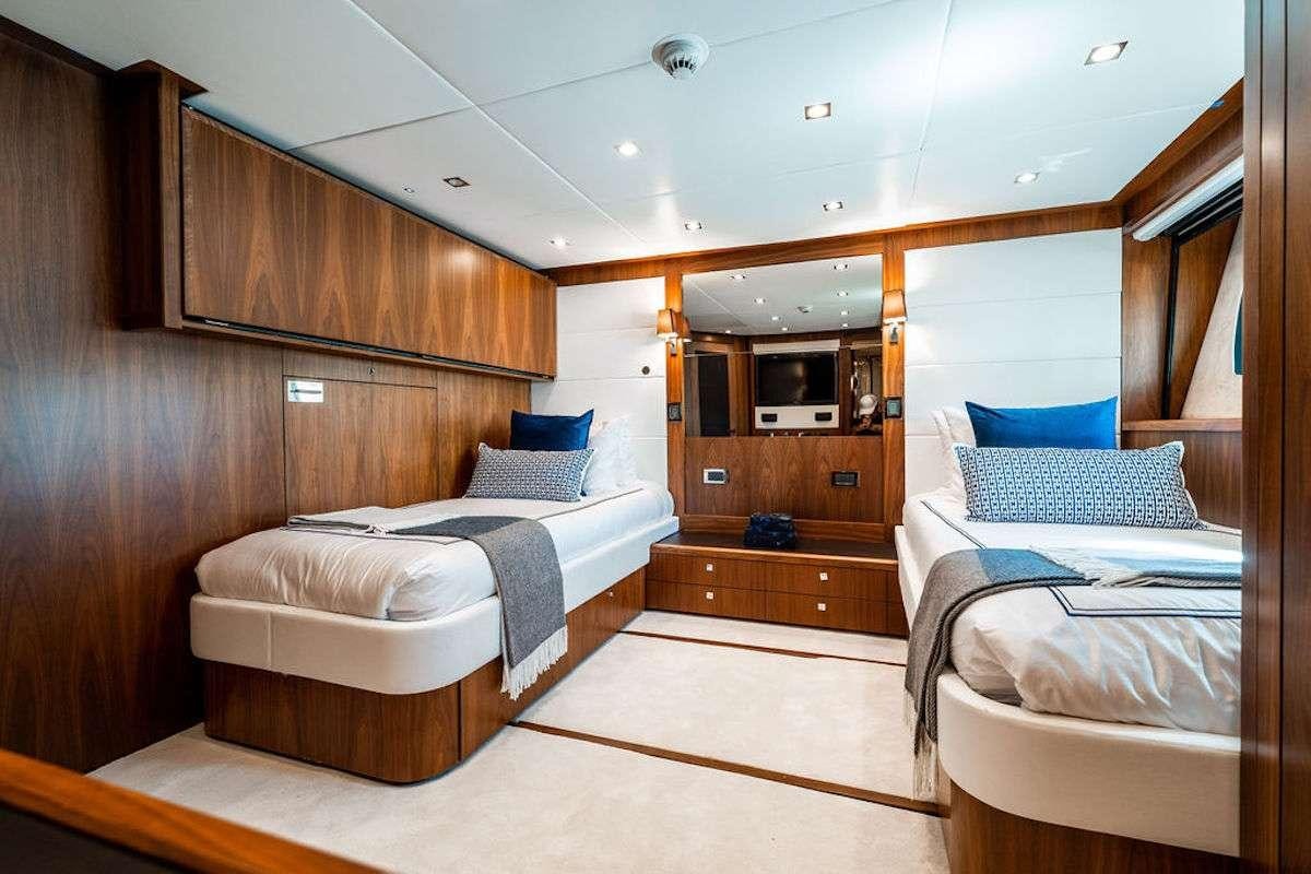 a room with a couple of beds aboard ABOUT TIME Yacht for Charter