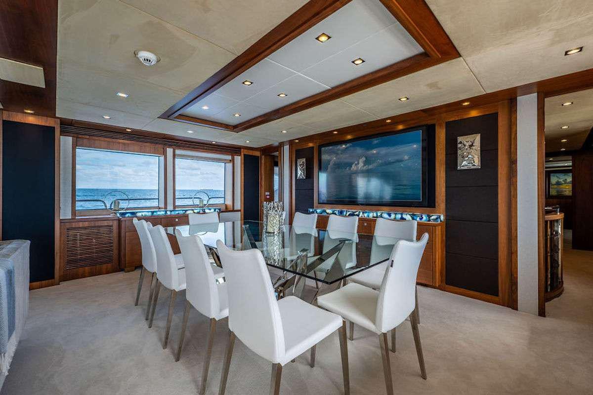 a room with tables and chairs aboard ABOUT TIME Yacht for Charter