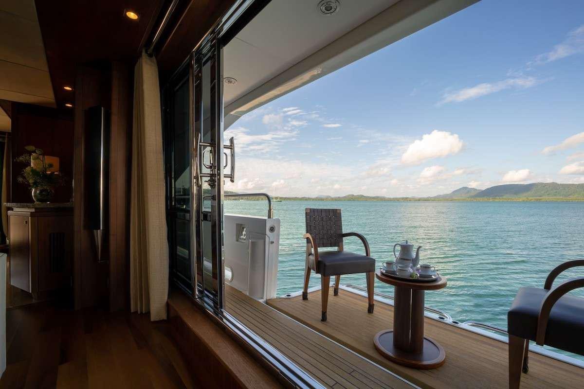 a room with a table and chairs on a deck aboard ABOUT TIME Yacht for Charter