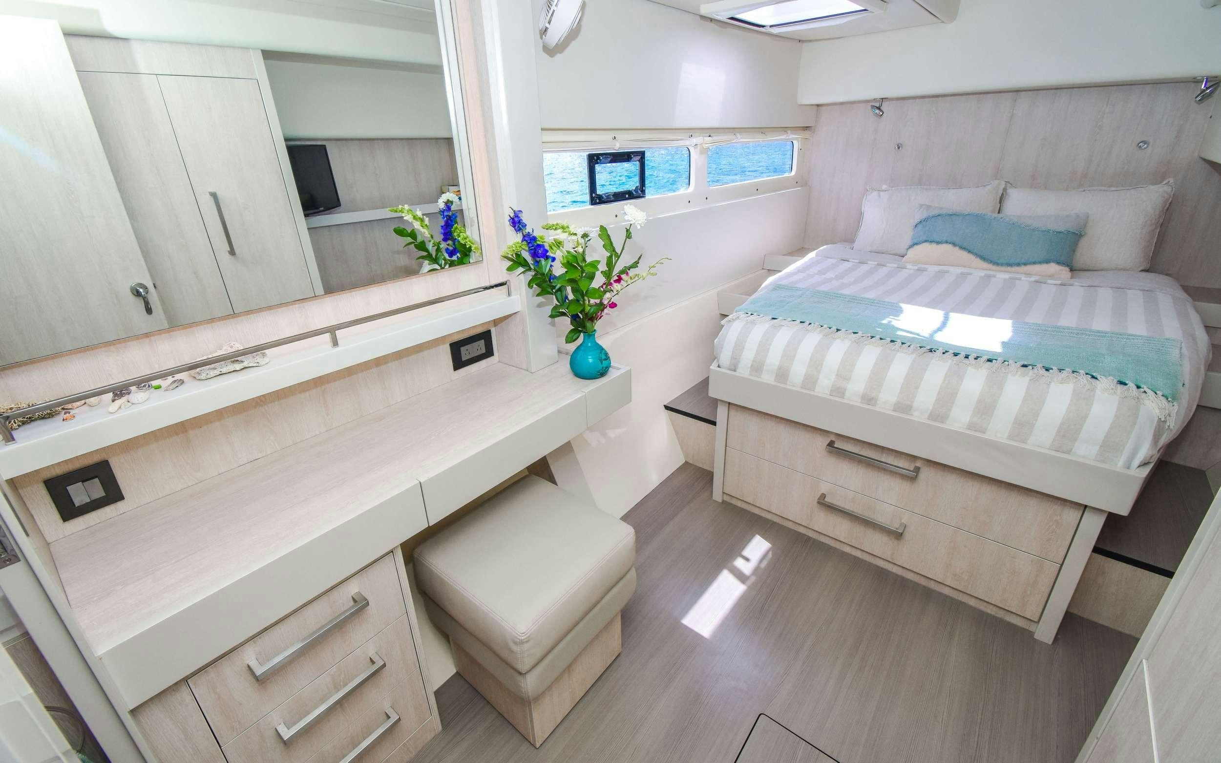 a room with a bed and a desk aboard LEEWAY Yacht for Charter