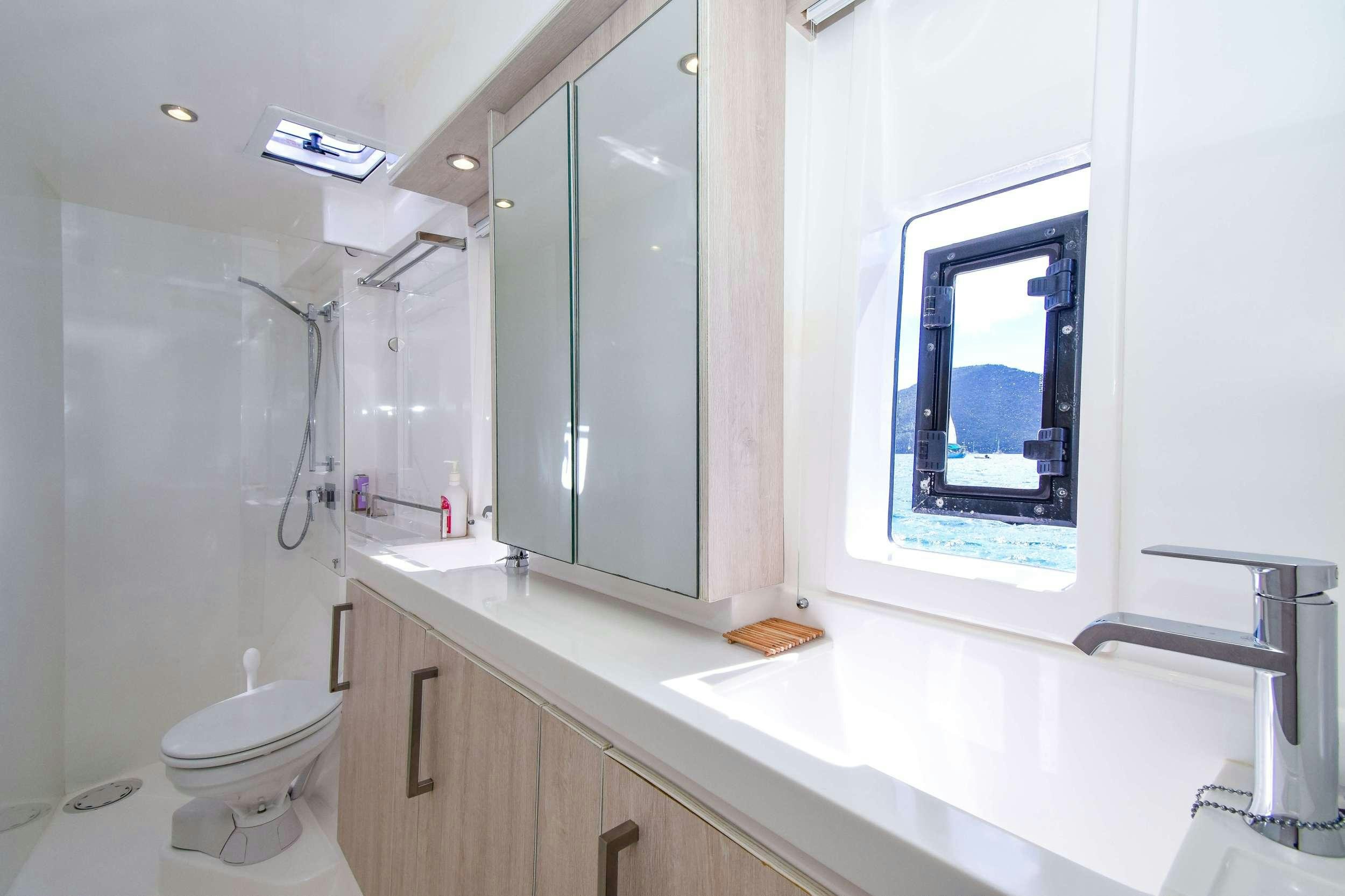 a bathroom with a large mirror aboard LEEWAY Yacht for Charter