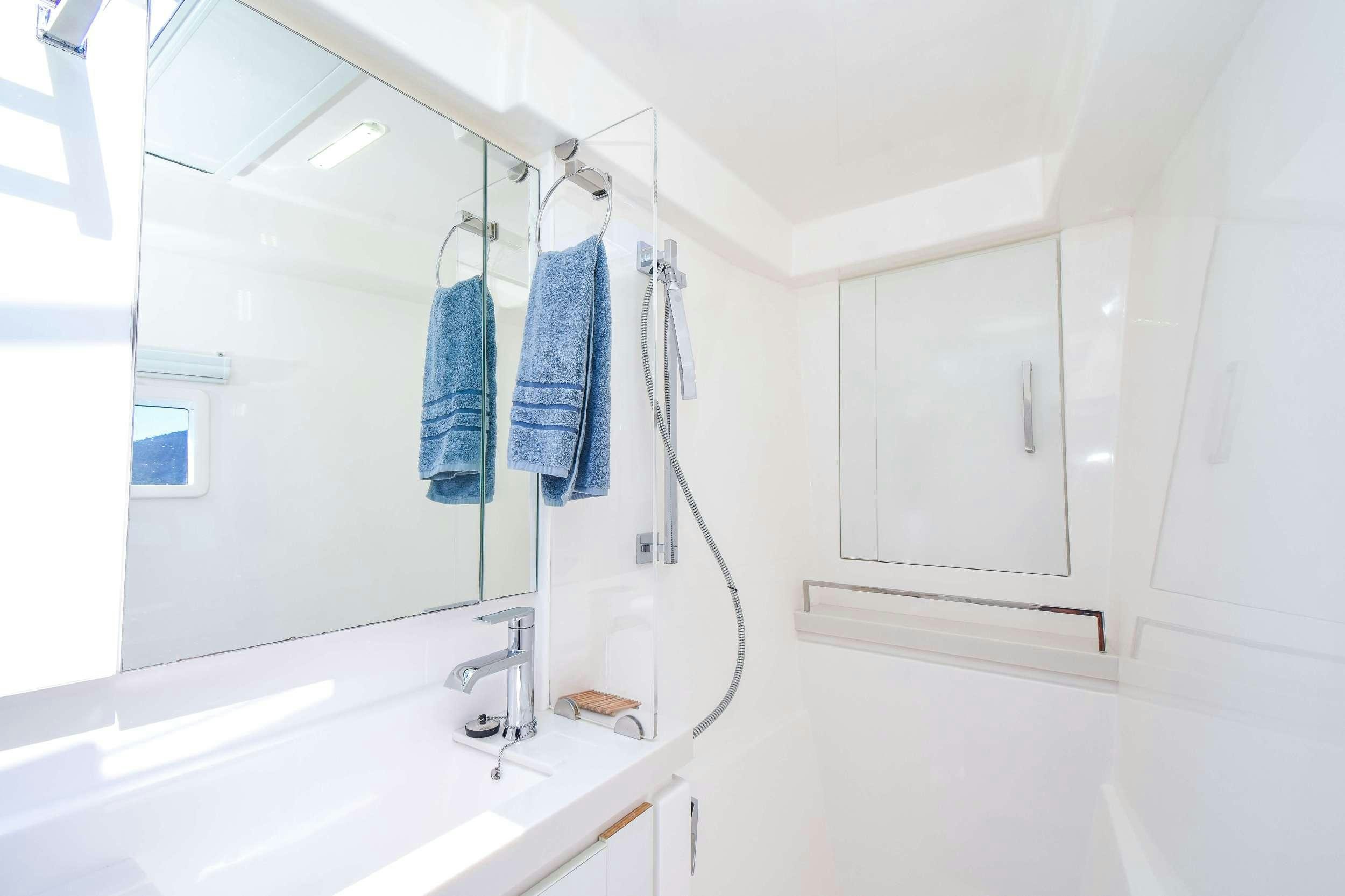 a bathroom with a sink and a mirror aboard LEEWAY Yacht for Charter